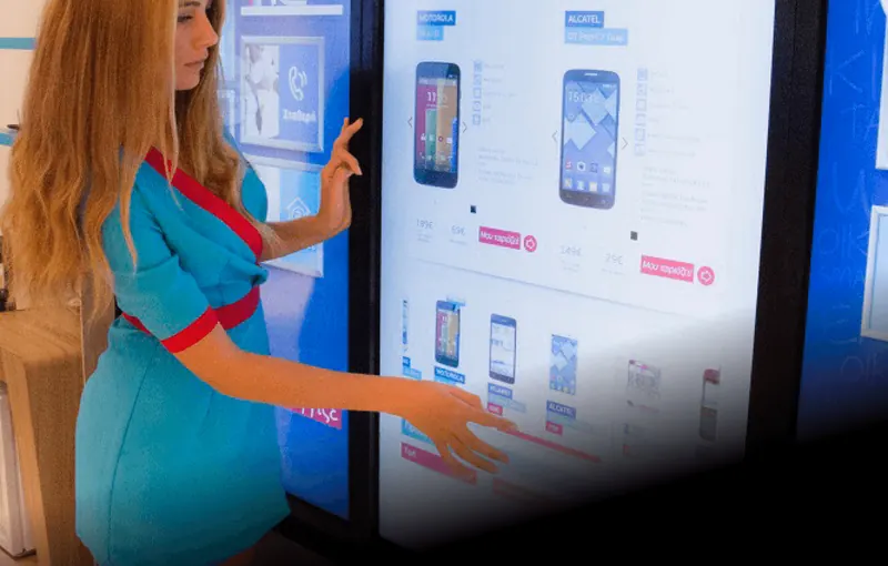 A woman using an endless aisle touch screen system