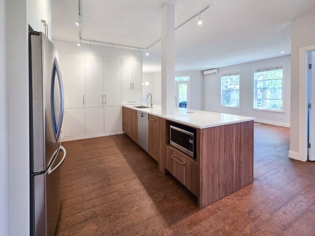 Image of KHD Homes kitchen design with island layout, stainless appliances, and modern cabinetry for luxury home renovations.