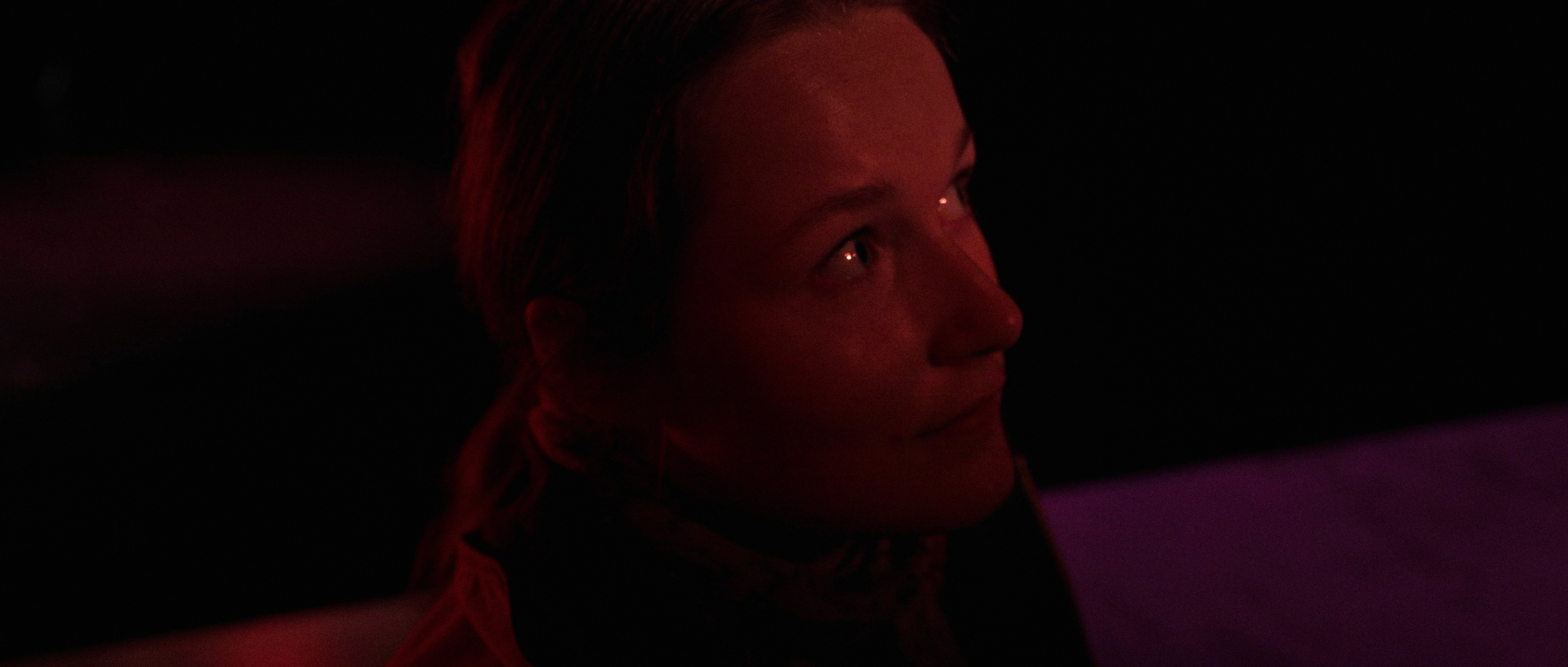 Artistic shot with red lighting gel, experimental cinematography.