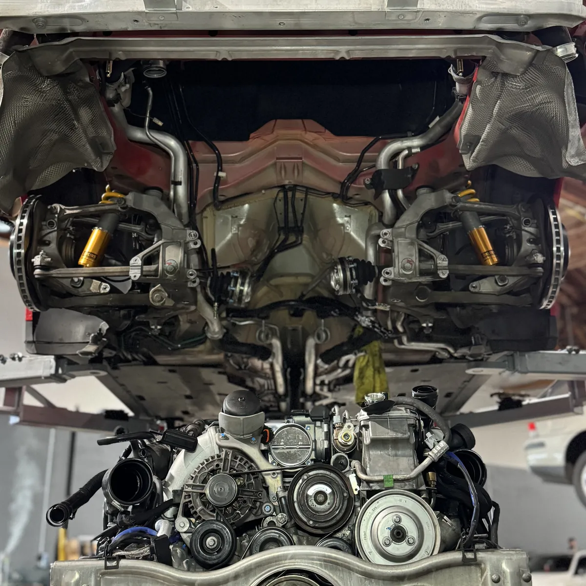 Rear suspension, brakes and underbody of a car raised on a lift at 714 Technik