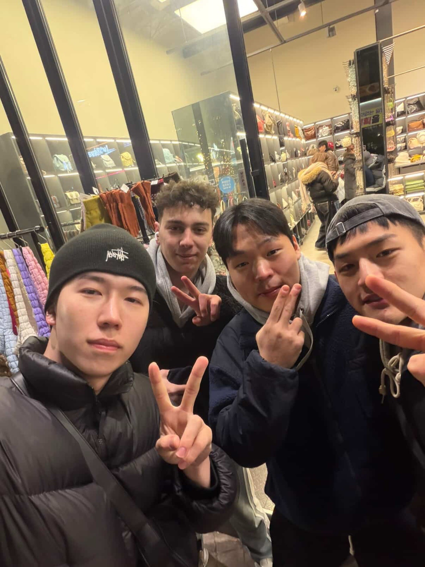 Close-up of a dark green leaf showing its textured surface and central vein against a muted background.