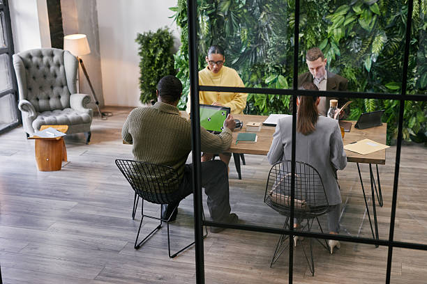 A group of people meet around a table to discuss changes to certification requirements