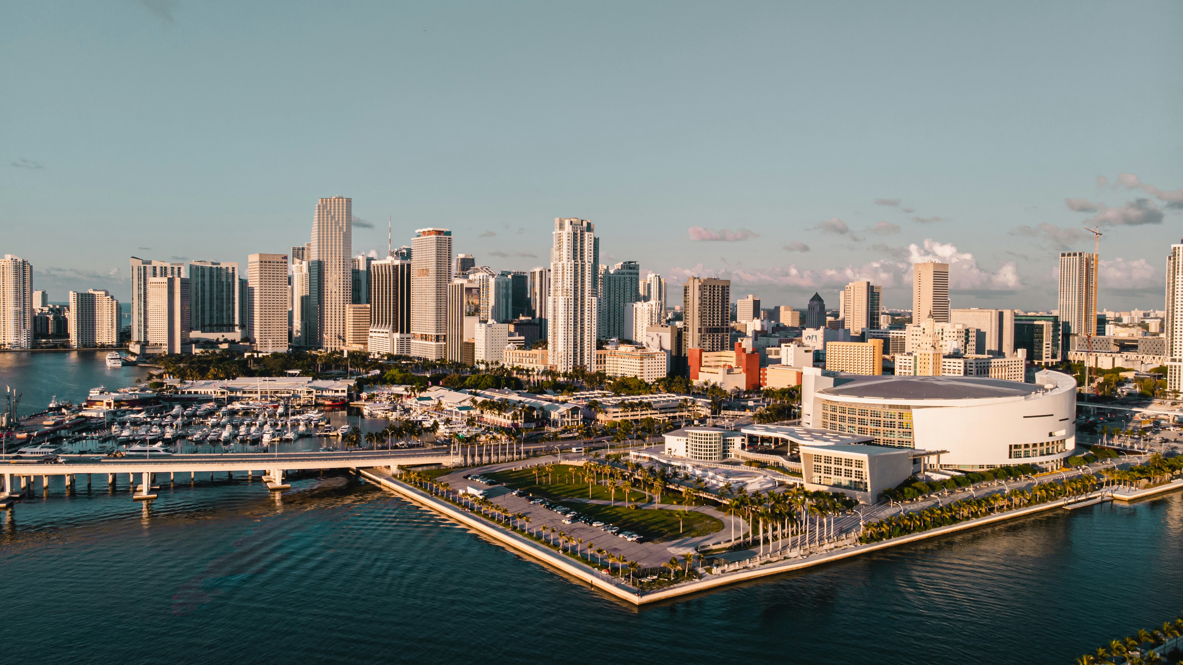 city skyline between sky and body of water