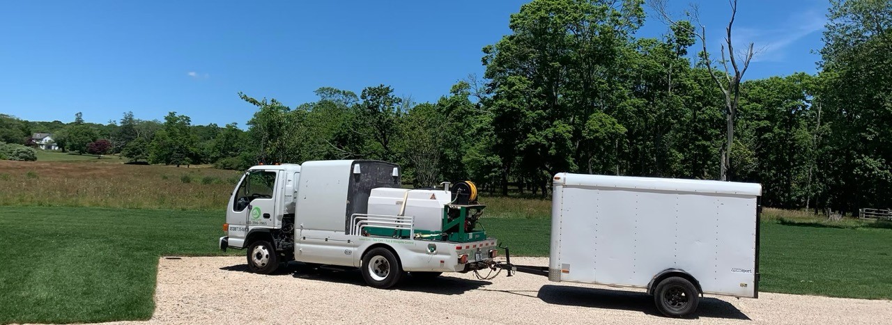 GM Turf Care truck and trailer parked at a job site