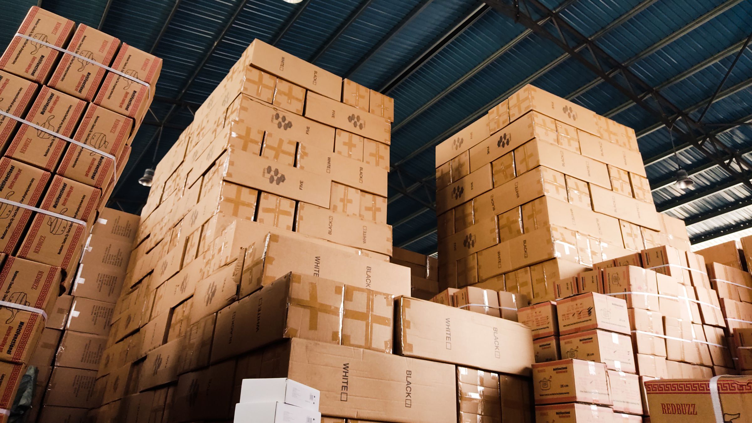 Stock pile of boxes in warehouse, excess holiday inventory 