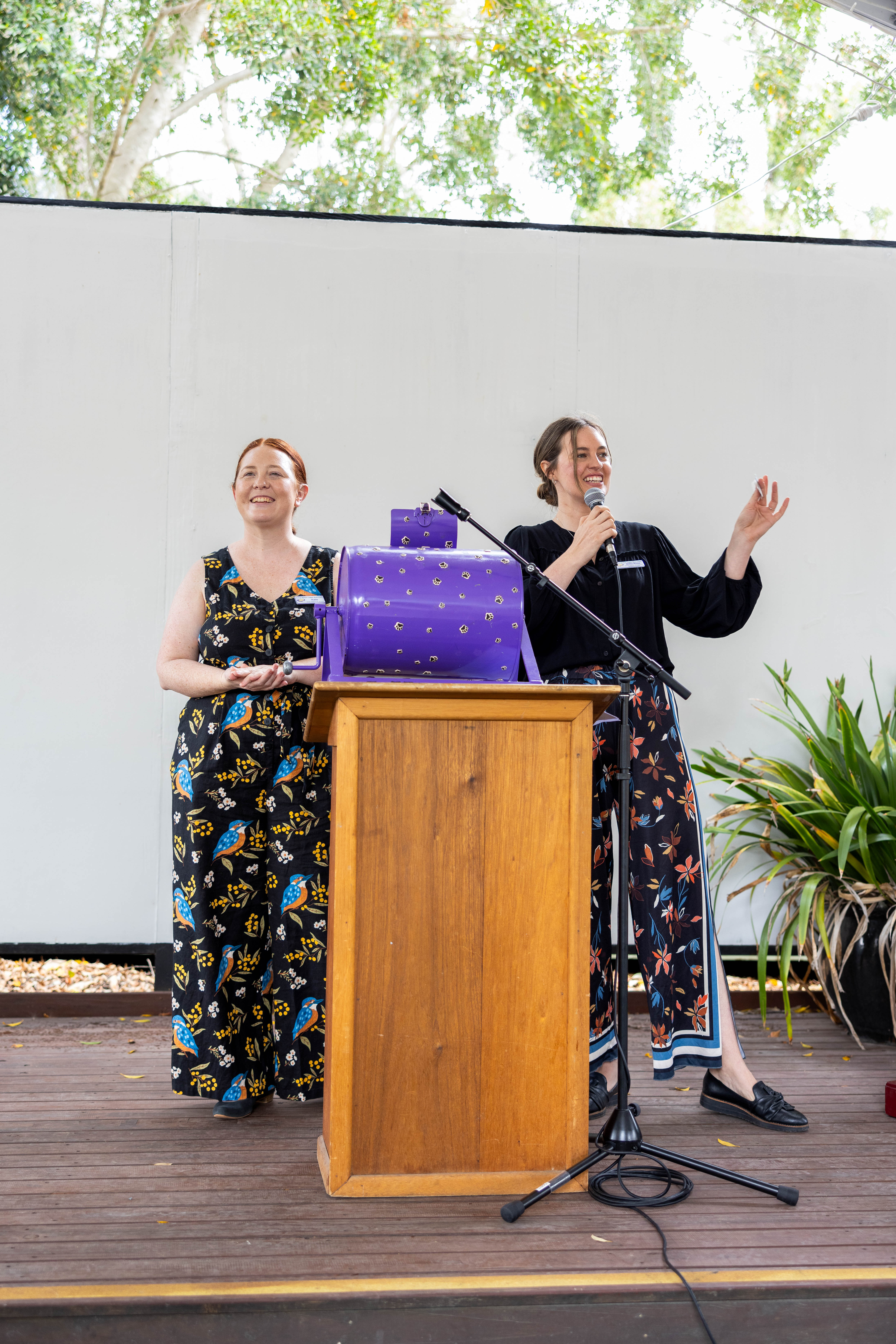 Two women presenting at outdoor podium