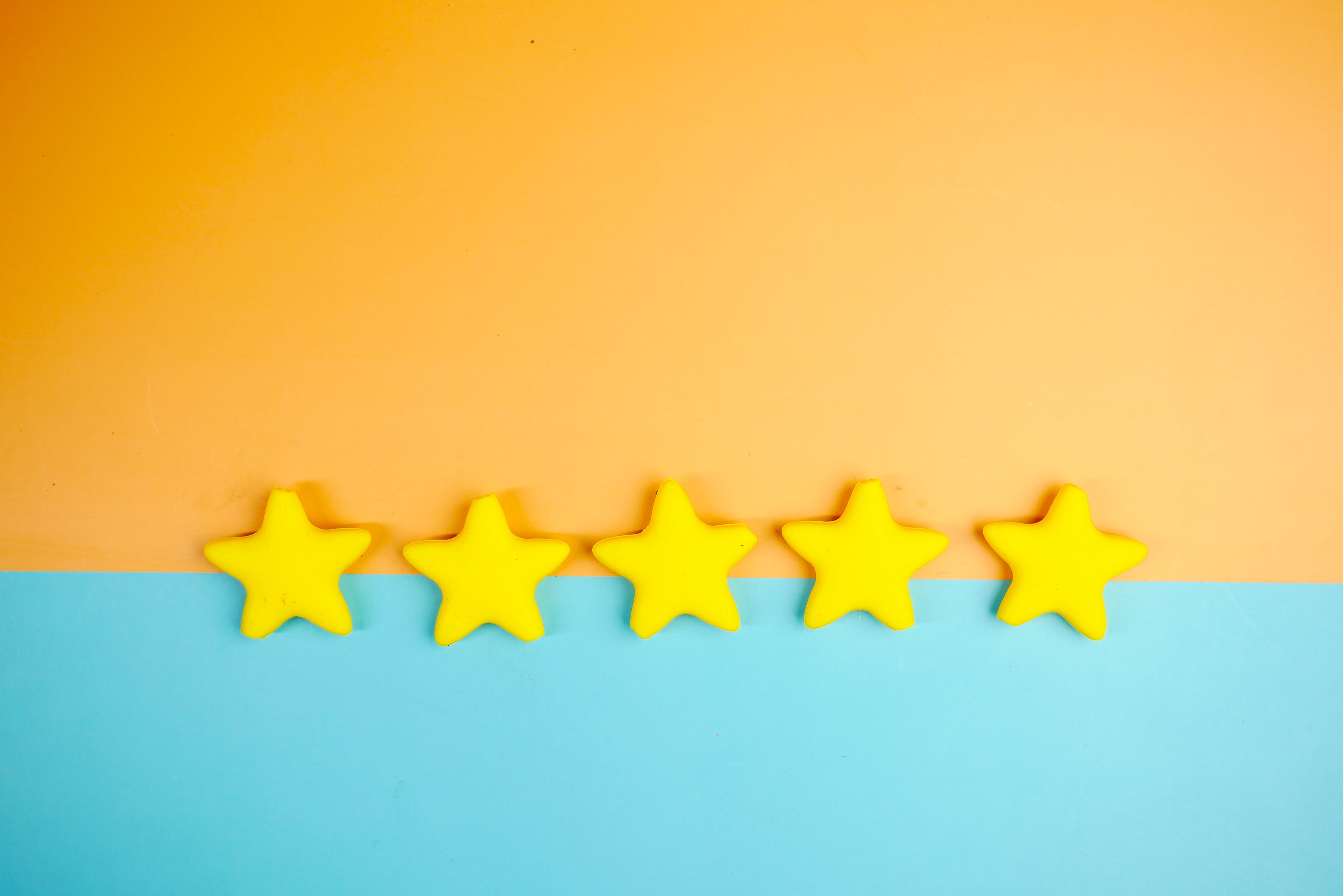 bright-yellow-stars-arranged-on-a-vivid-orange-and-blue-background-with-copy-spa - towfiqu-barbhuiya (pexels)