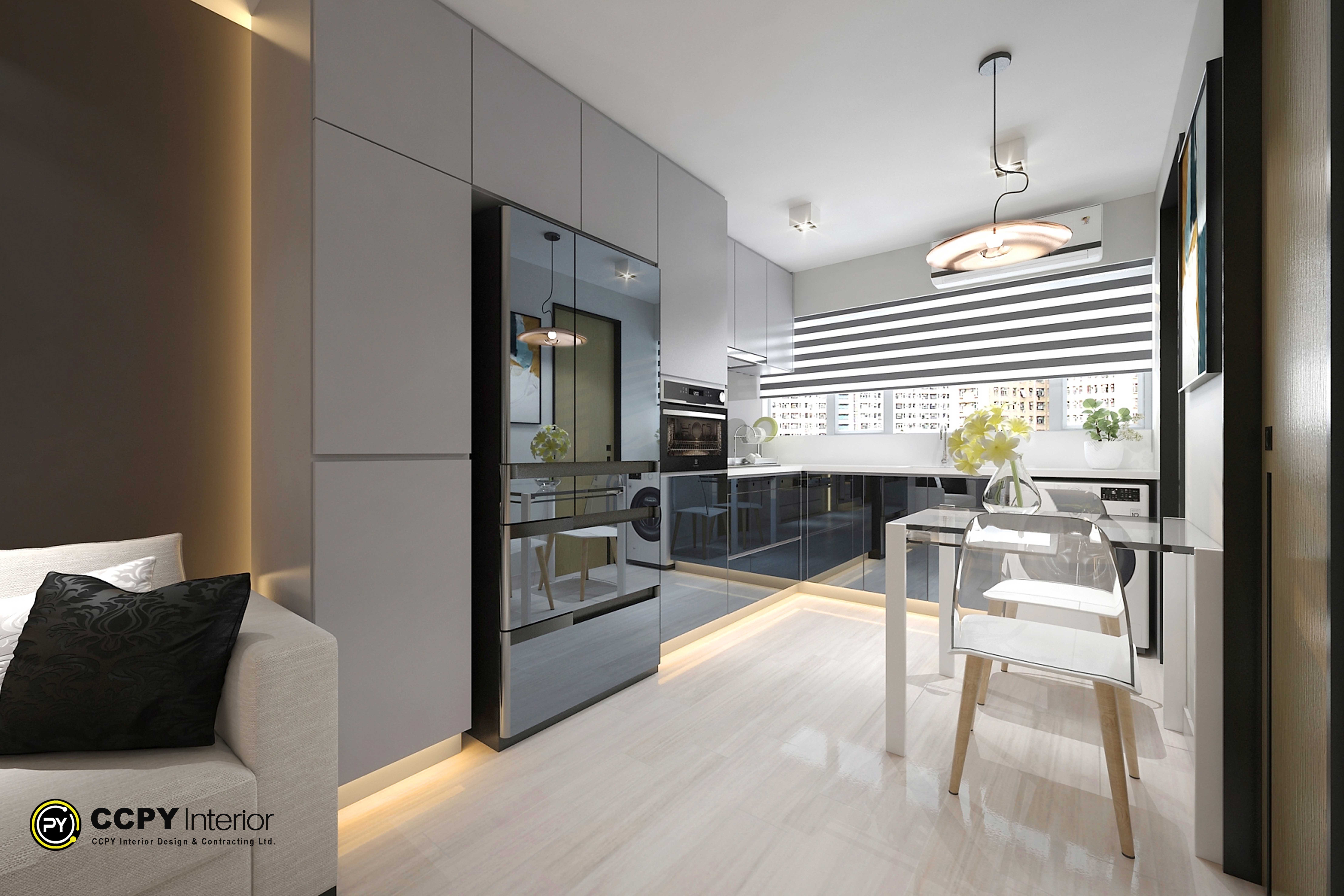 Pok Yat House's interior design project has an open-concept kitchen and living area with a contemporary, space-efficient layout. A small dining/work table and simple handleless cabinets with dark glossy lower cabinets and light gray upper cabinets are important features. Space efficiency is improved by built-in appliances like an integrated oven and a high-gloss dark refrigerator. Under-cabinet LED strips and a modern pendant light provide lighting, and a matching backsplash and white marble-patterned countertops guarantee a unified look.