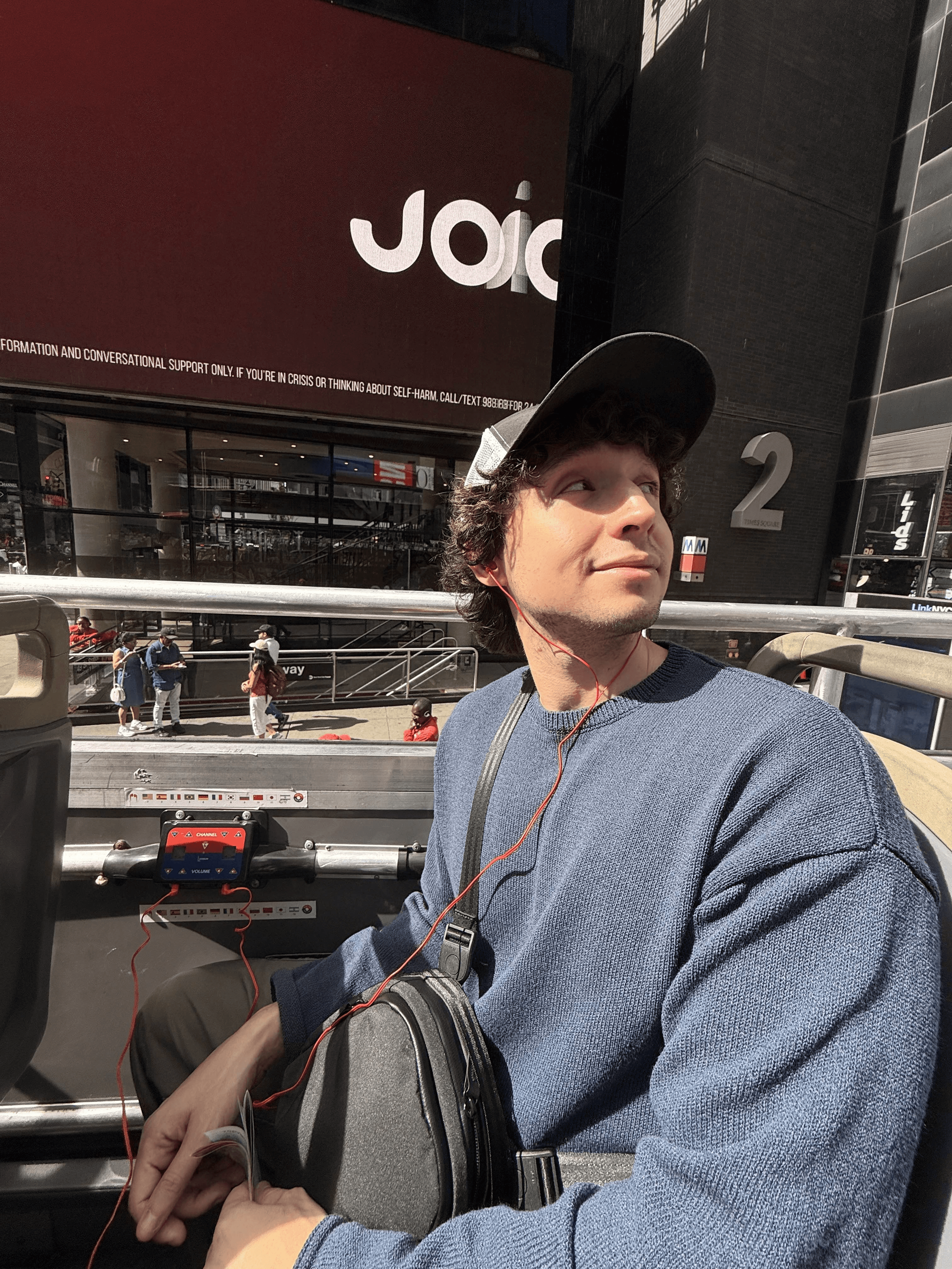 Portrait of a person in dark clothing speaking on a phone