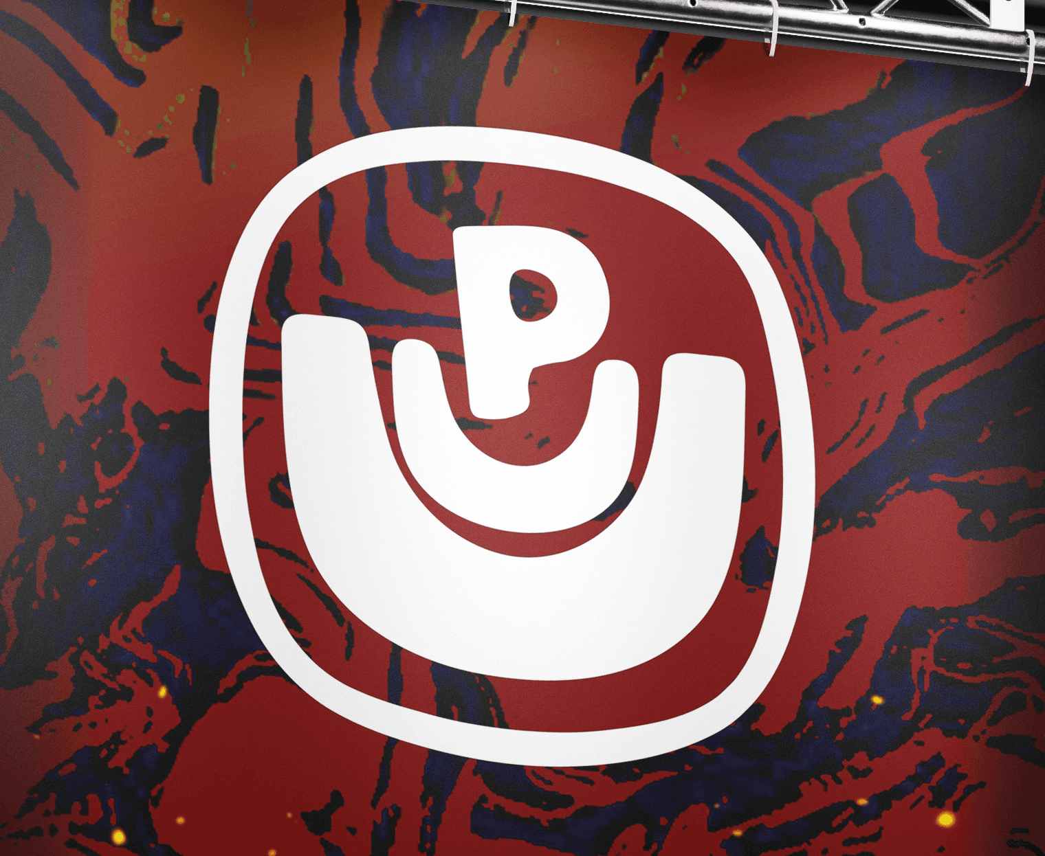 UUP Festival branded hanging banner with logo and "Main Stage" text on red abstract background, suspended from a metal truss at a concert venue