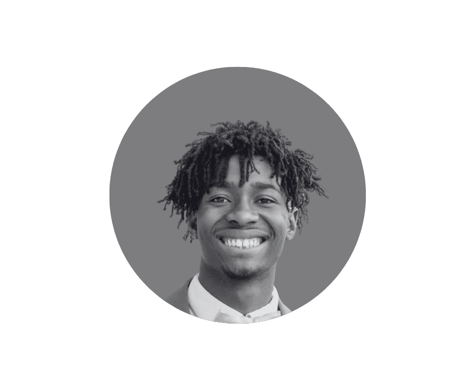 Portrait of a man with short dark hair and a trimmed beard, dressed in a dark shirt, on a simple background.