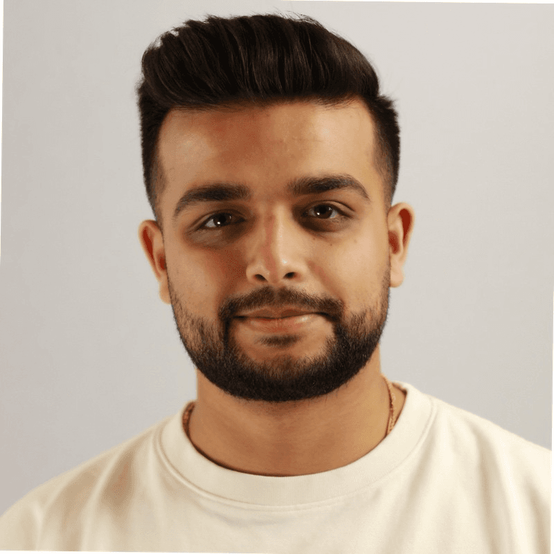 A man works on a laptop in an office.