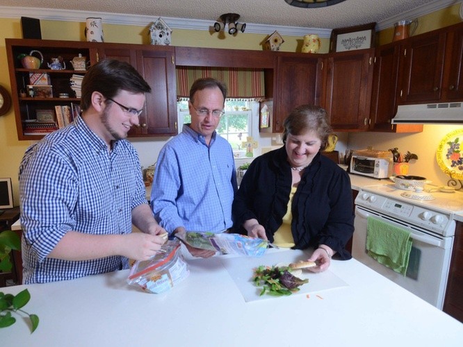 Parents and son preparing food
