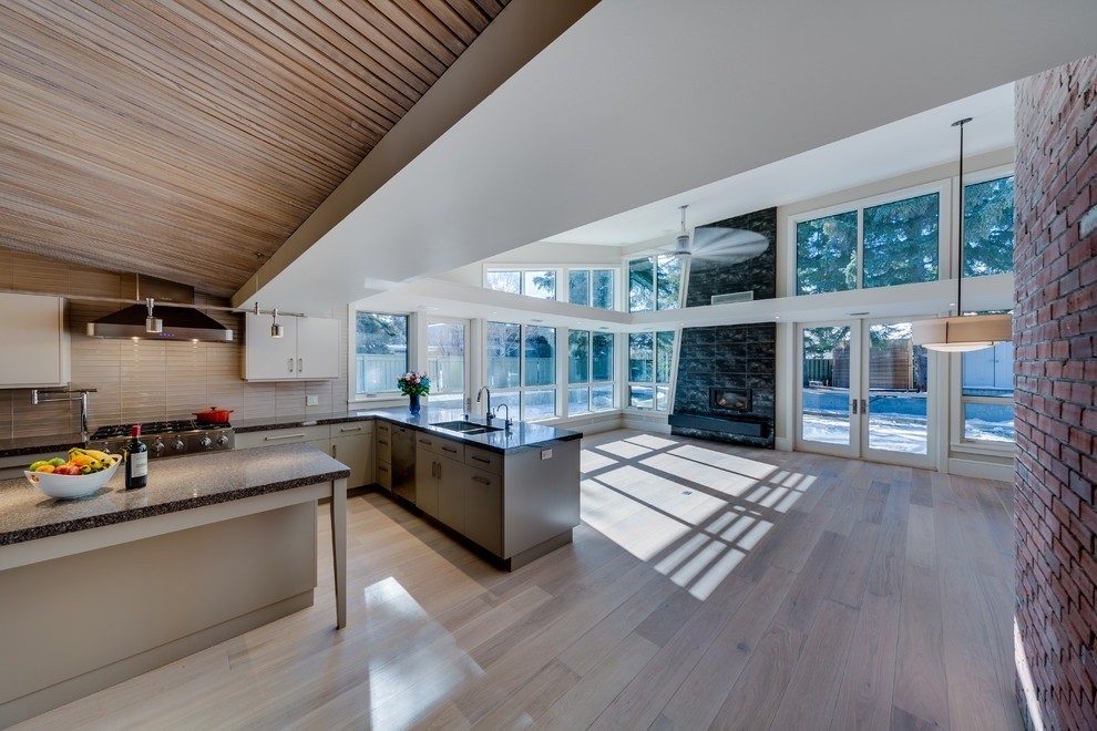 Image of Modern kitchen with island, large windows, and wood accents, by KHD Homes, showcasing interior design expertise.