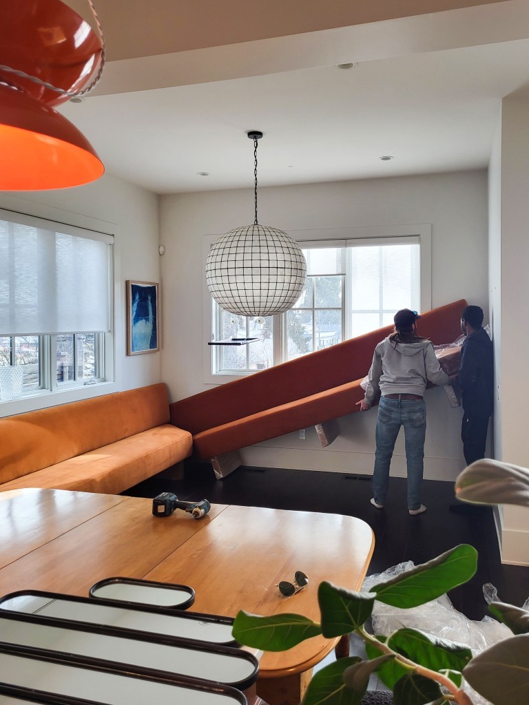 Image of KHD Homes construction team installing staircase with modern furniture and interior design elements in home renovation.