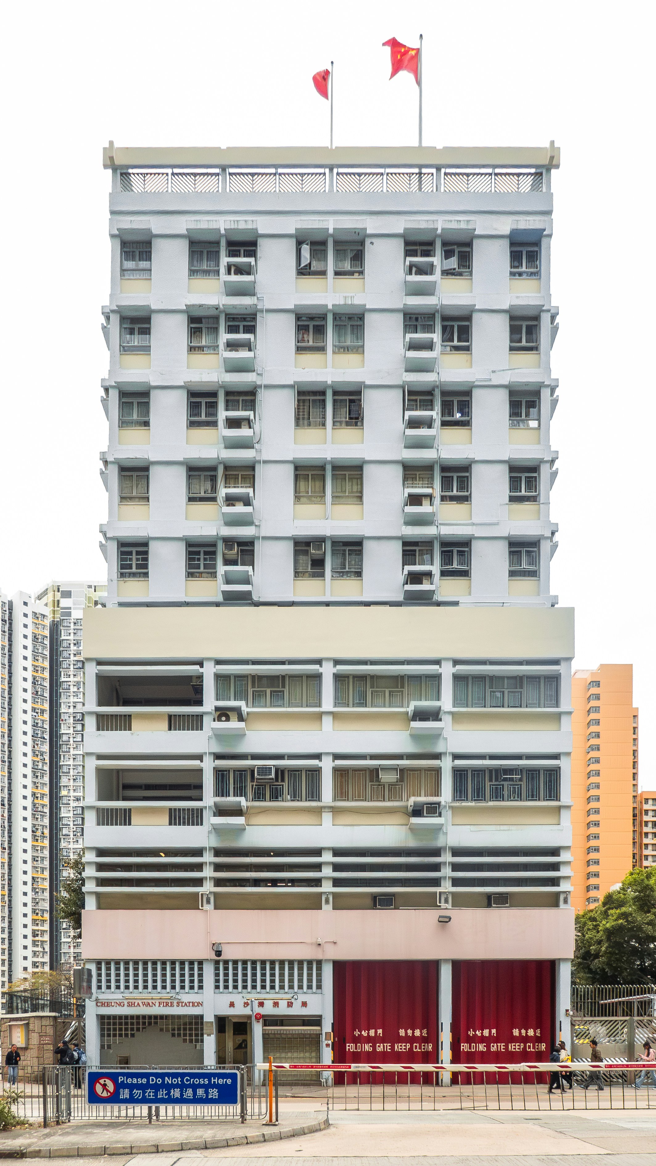 A large white building with a red flag on top of it