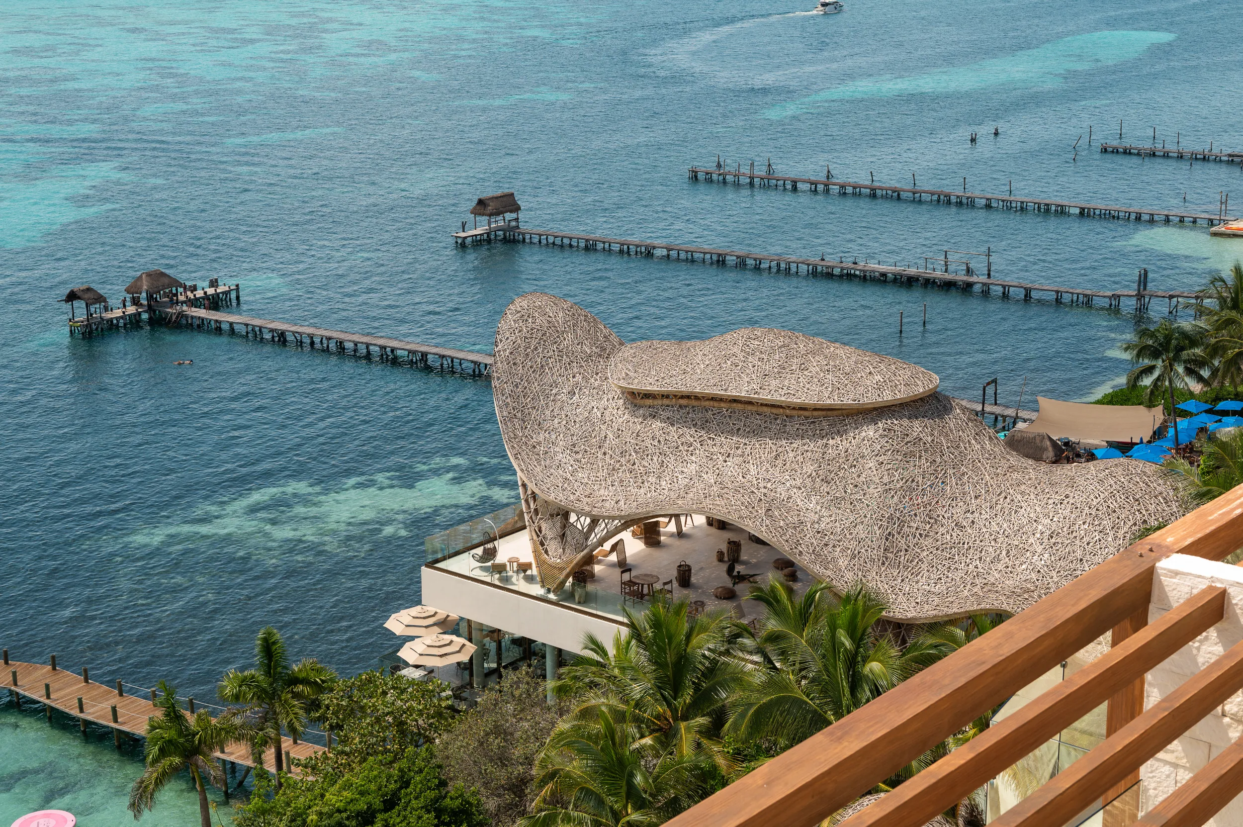 High-angle perspective of the bio-parametric bamboo roof at Hyatt Impressions, optimized through Python algorithms and genetic design for structural efficiency.