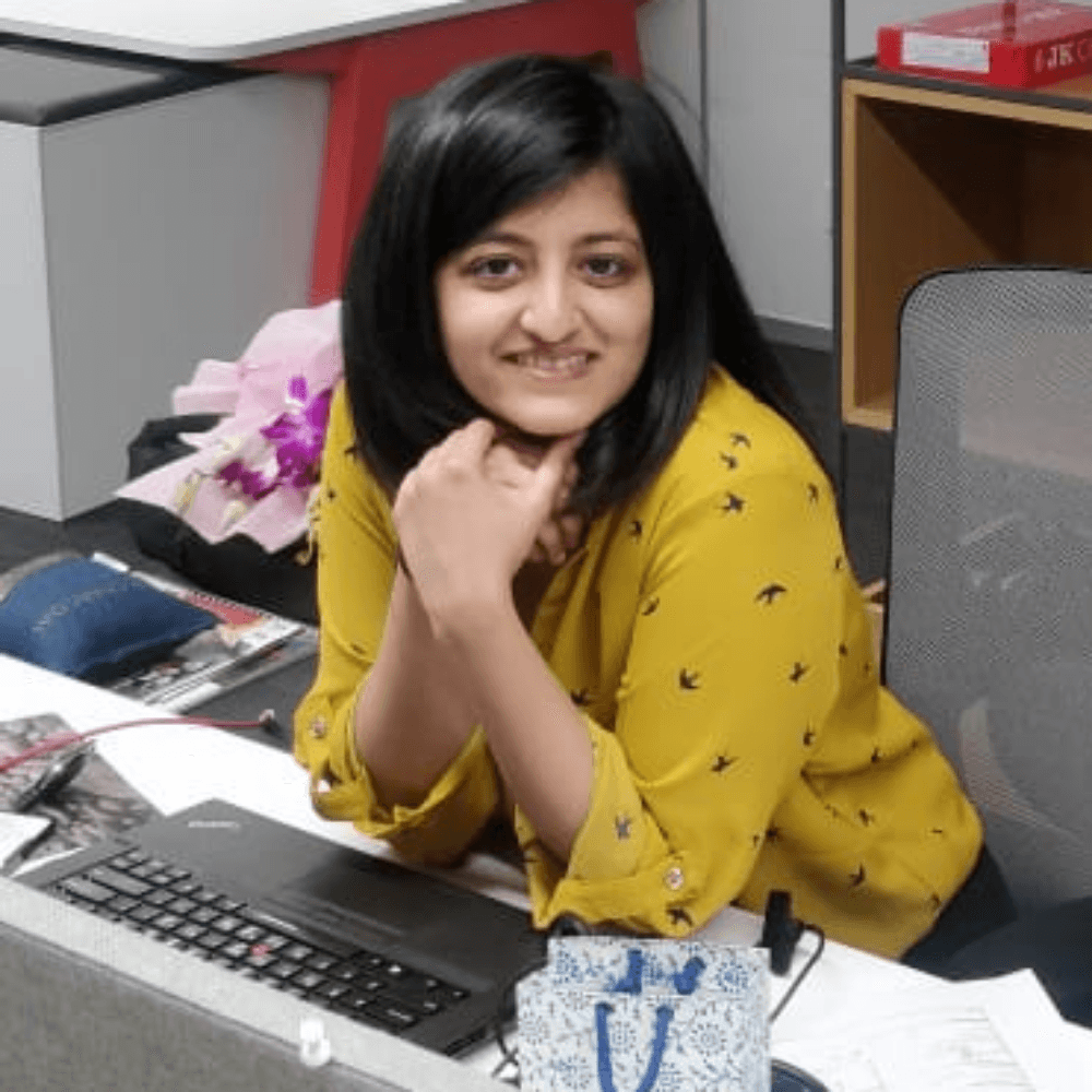 A young woman poses for a black and white photo.