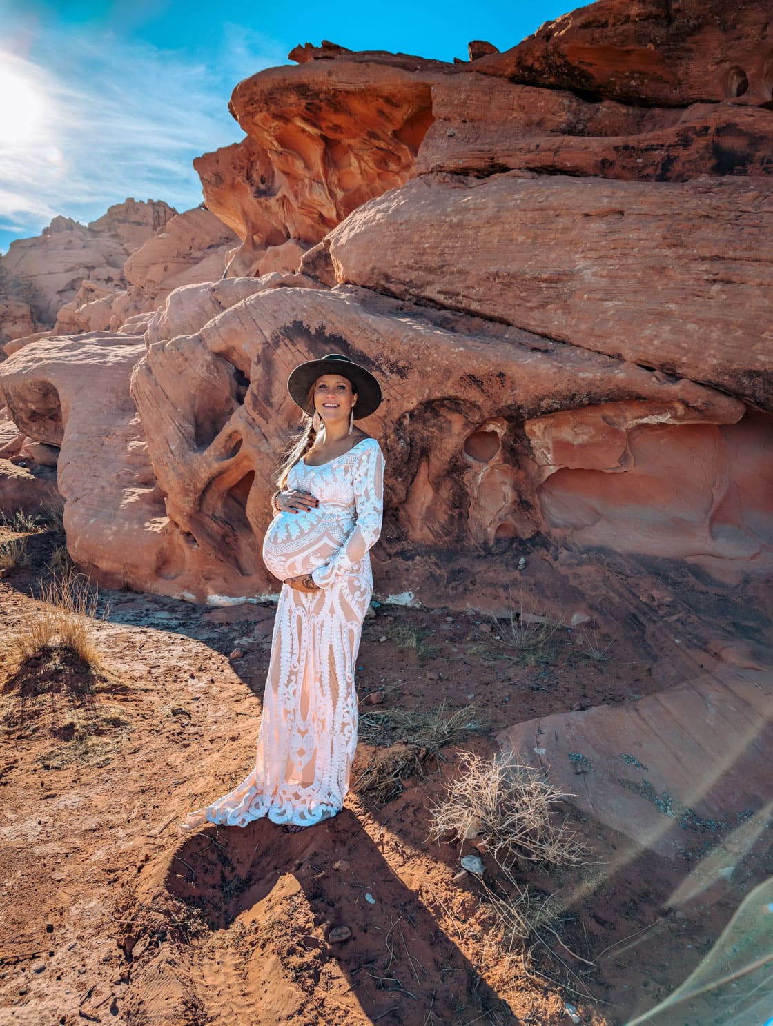 Pregnant Bre in the Desert during a blessingway ceremonial, surrounded by the red rocks and bright blue skies.