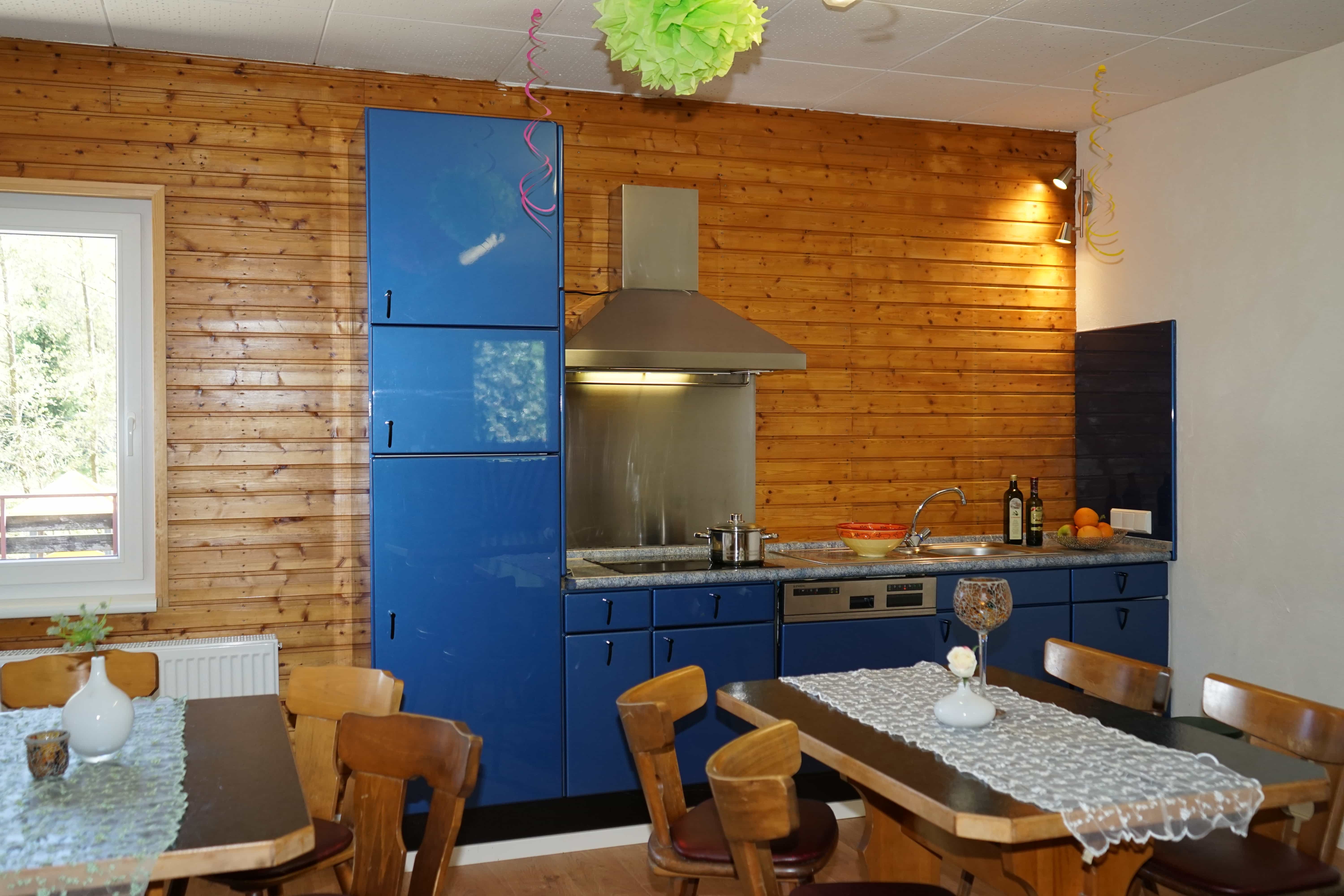 Group room with tables, chairs, and kitchen