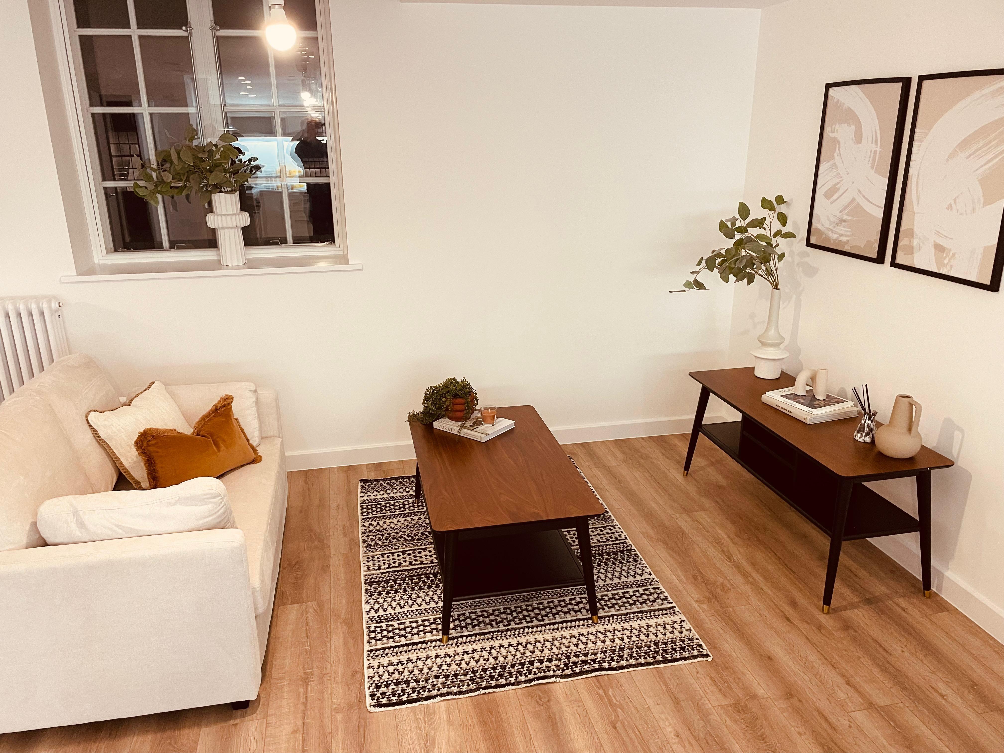 Warm timber tones and neutral fabrics in living room of show flat designed by White Circle