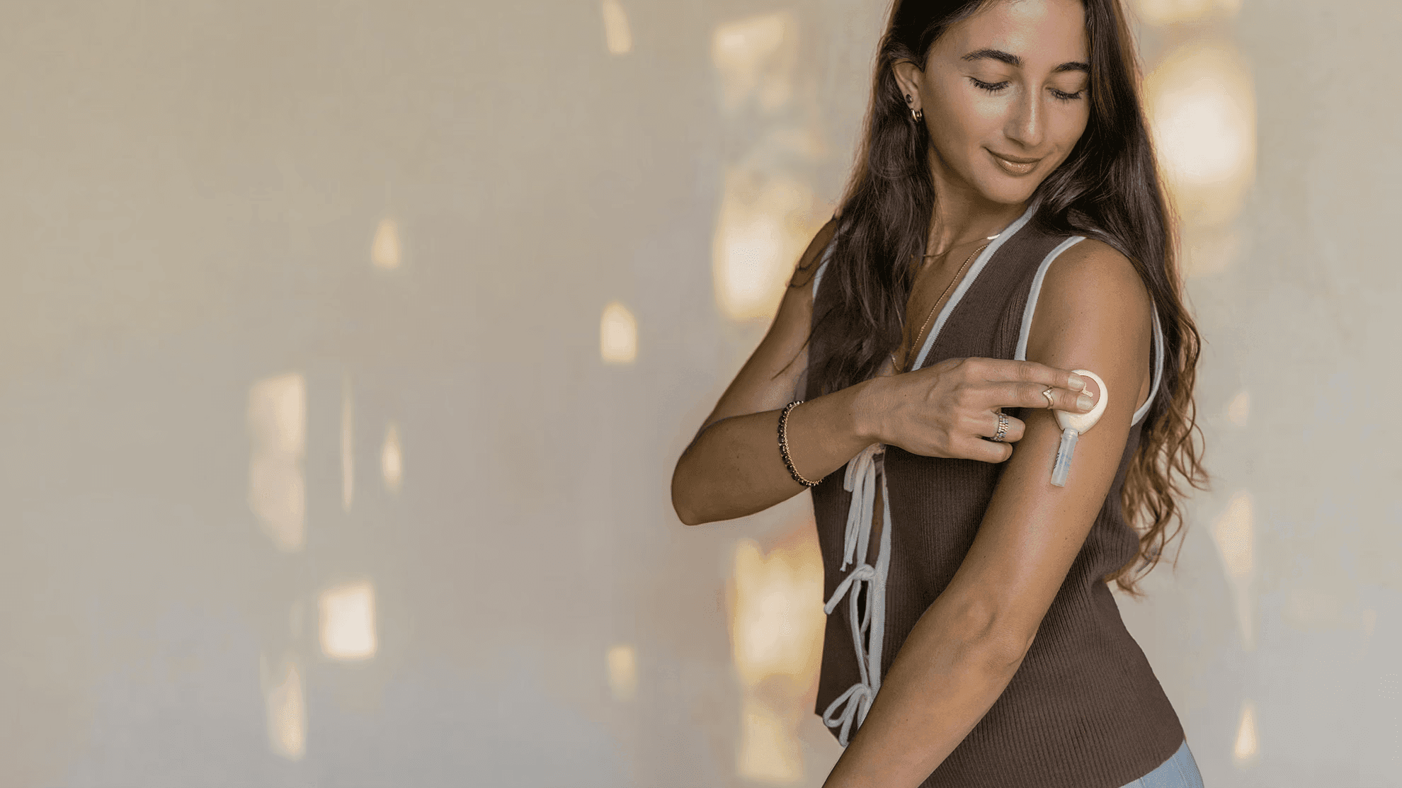 Woman collecting a blood sample from his upper arm using an at-home test kit.