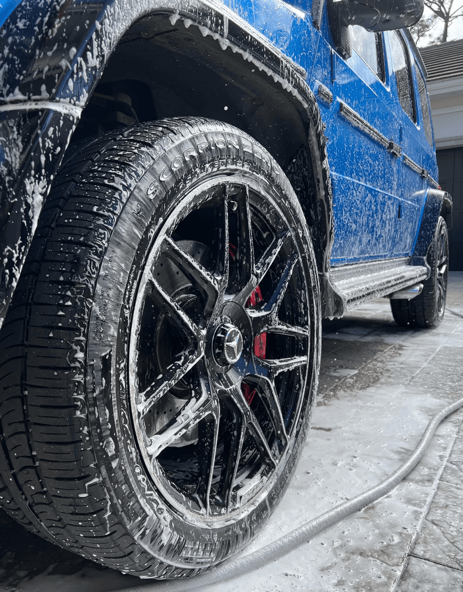 Blue G-Wagon getting detailed by gulfstream mobile detailing right after a foam cannon hand wash