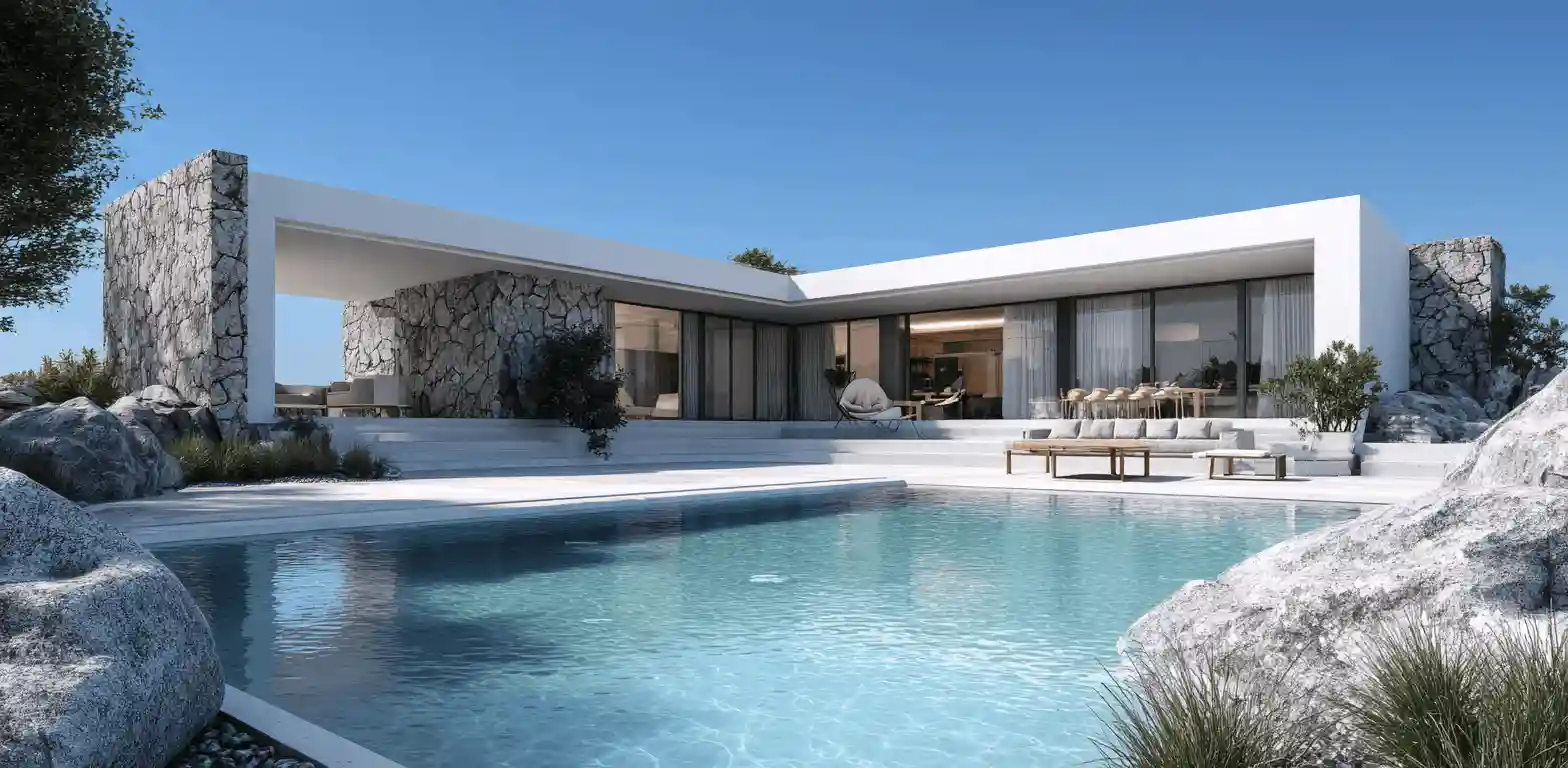Modern L-shaped villa with white minimalist framing and stone walls, featuring a luxury infinity pool and outdoor lounge area under a clear blue sky.