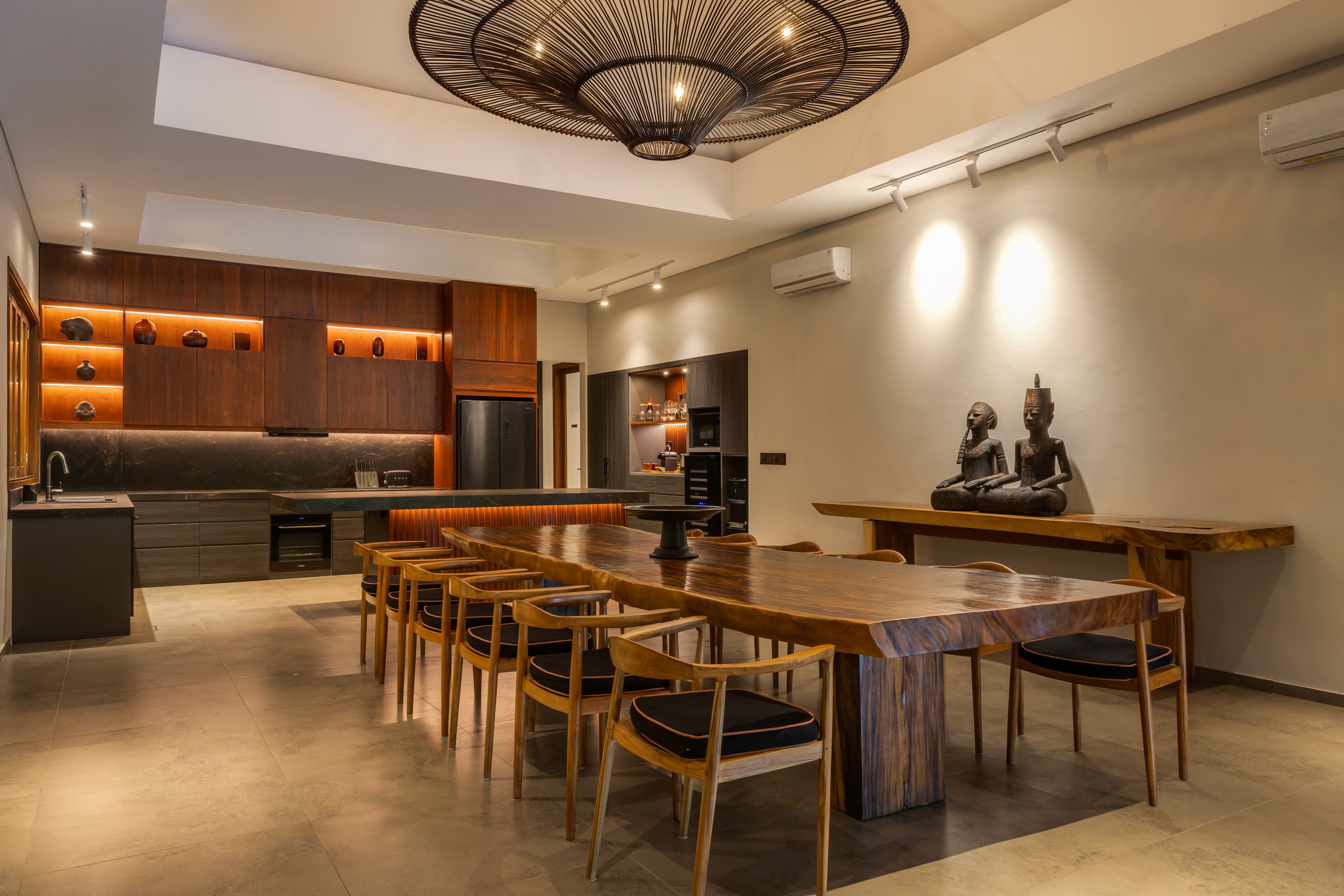 Modern living room with black leather sofas and tree-patterned rug