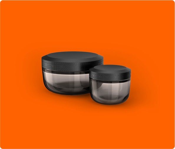 Sleek black cannabis grinder designed by a product development firm, showcased against a bold orange backdrop. Modern and functional product design.