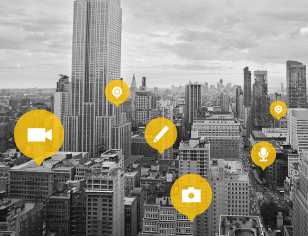A black and white cityscape with tall buildings is shown from a high vantage point. Multiple yellow circles containing icons are scattered across the image: a video camera on the left, a pencil in the center, a microphone icon on the right, and a camera icon at the bottom center. The sky is cloudy.
