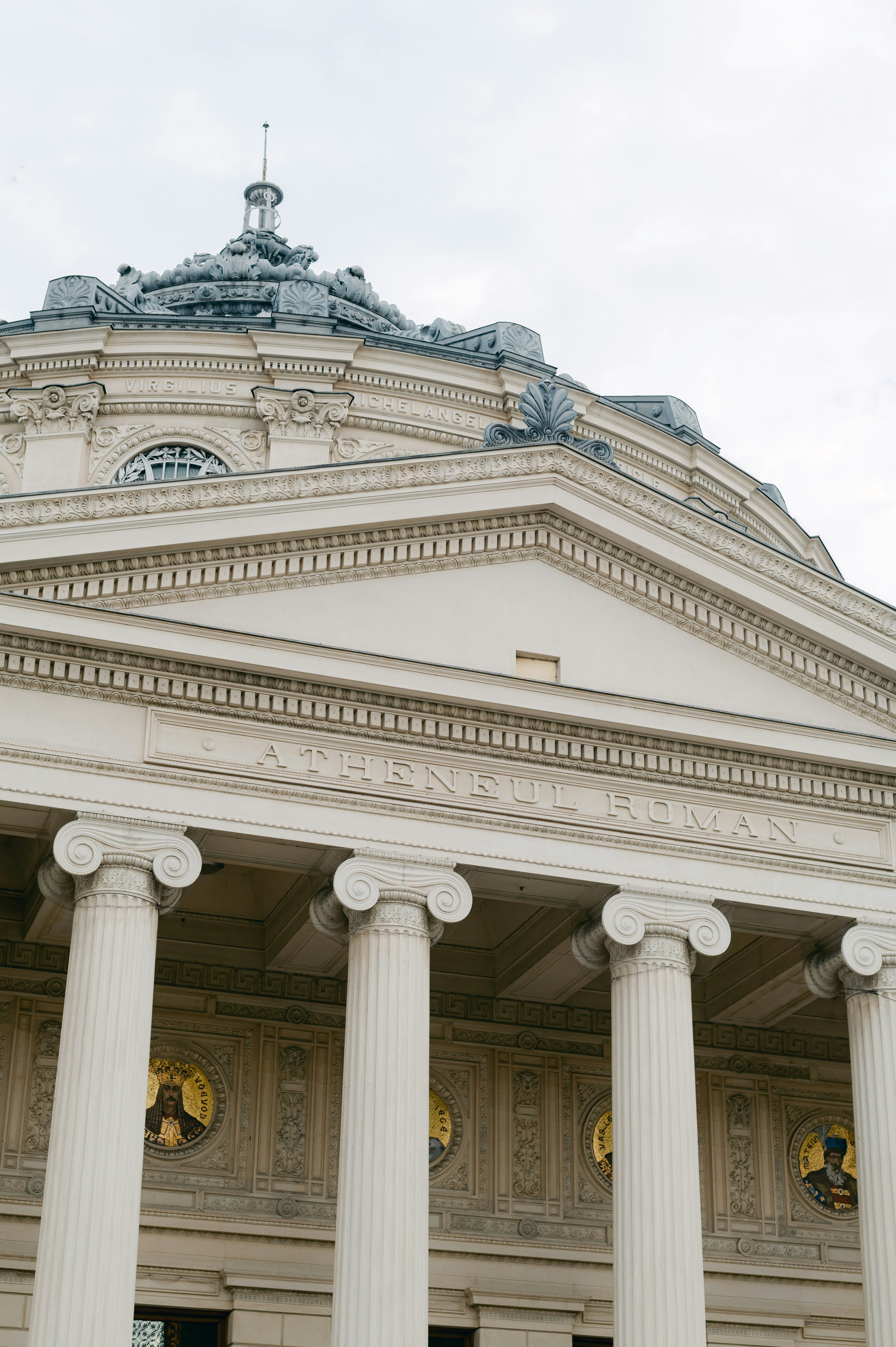 a building with columns and a statue on top