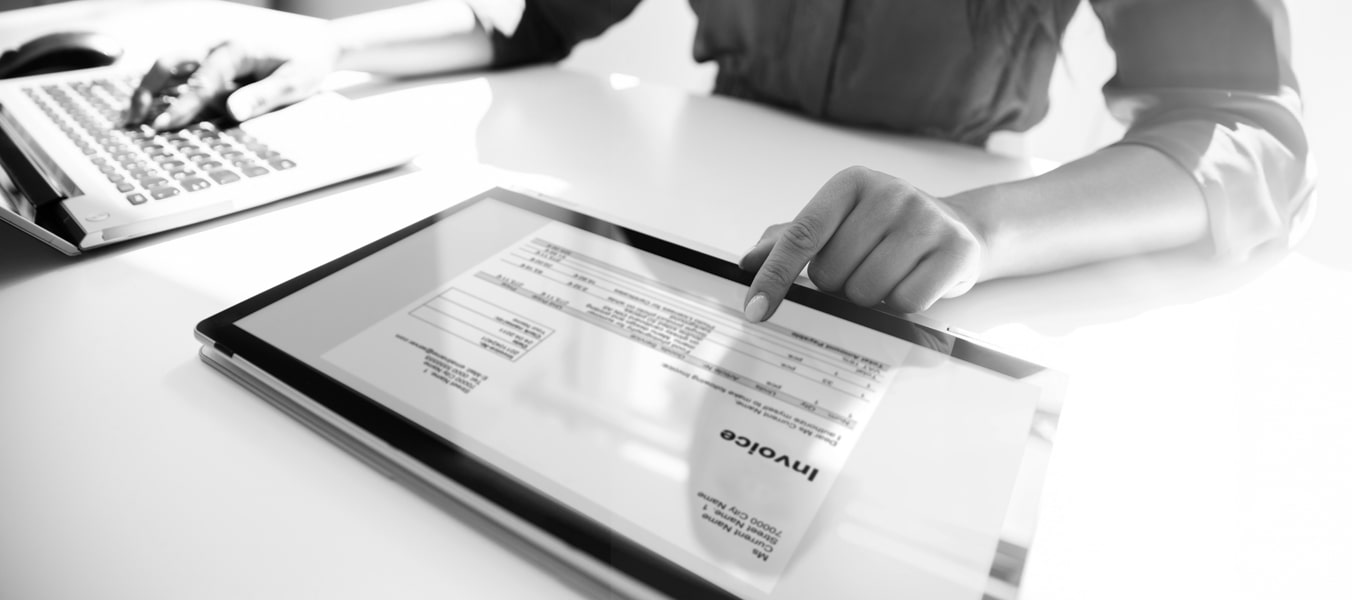 Business woman checking an invoice on her tablet