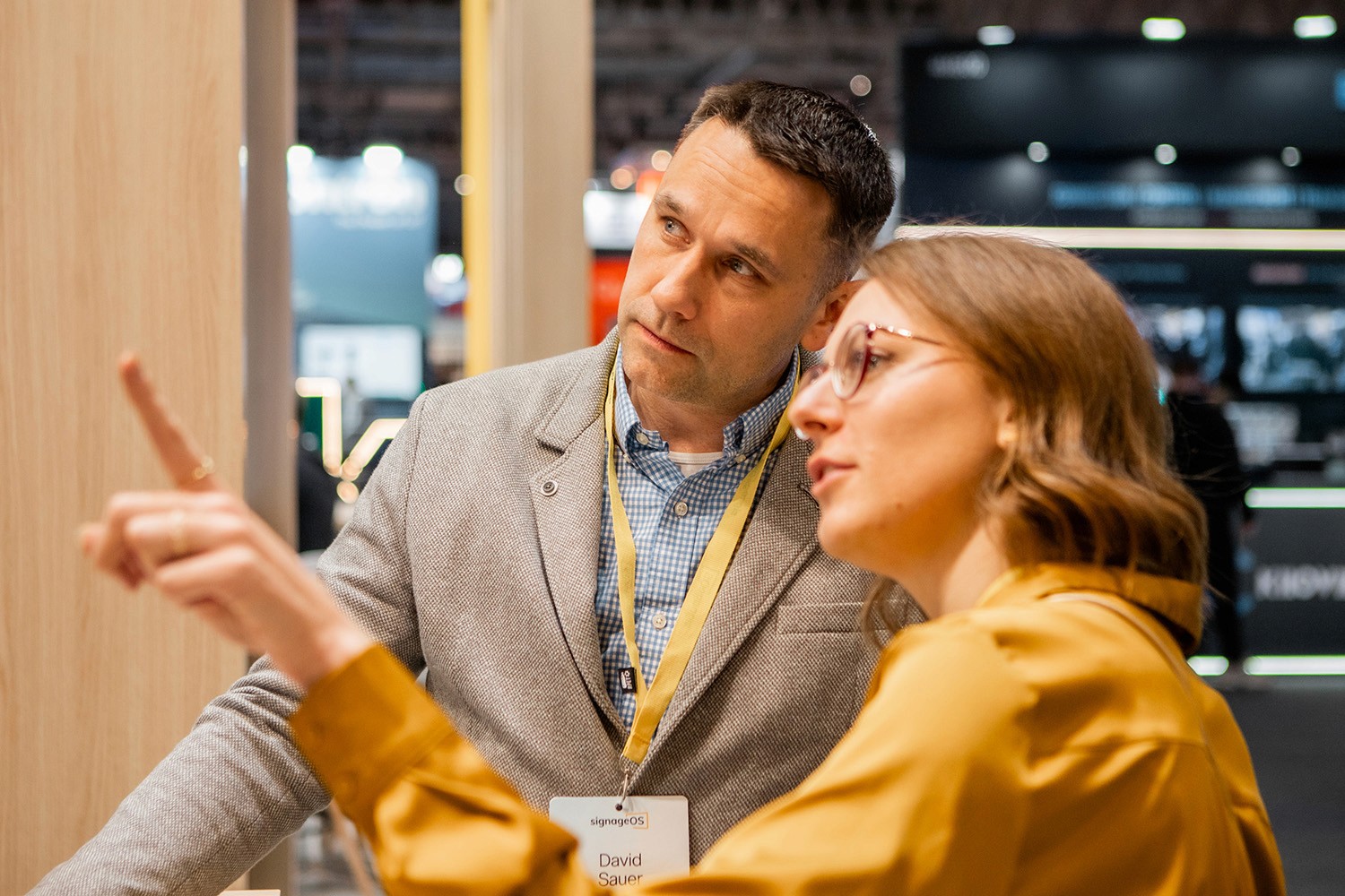 A photograph of people using CloudControl by signageOS to monitor and control digital signage devices