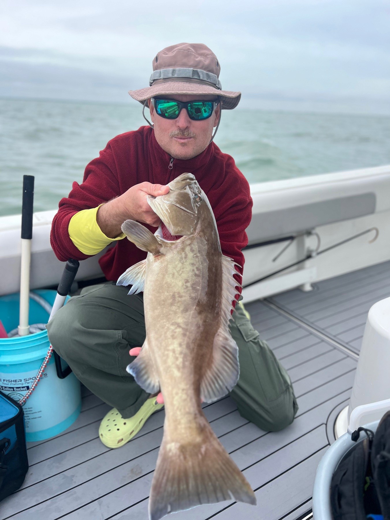 Angler holding a grouper caught on a Bradenton fishing charter