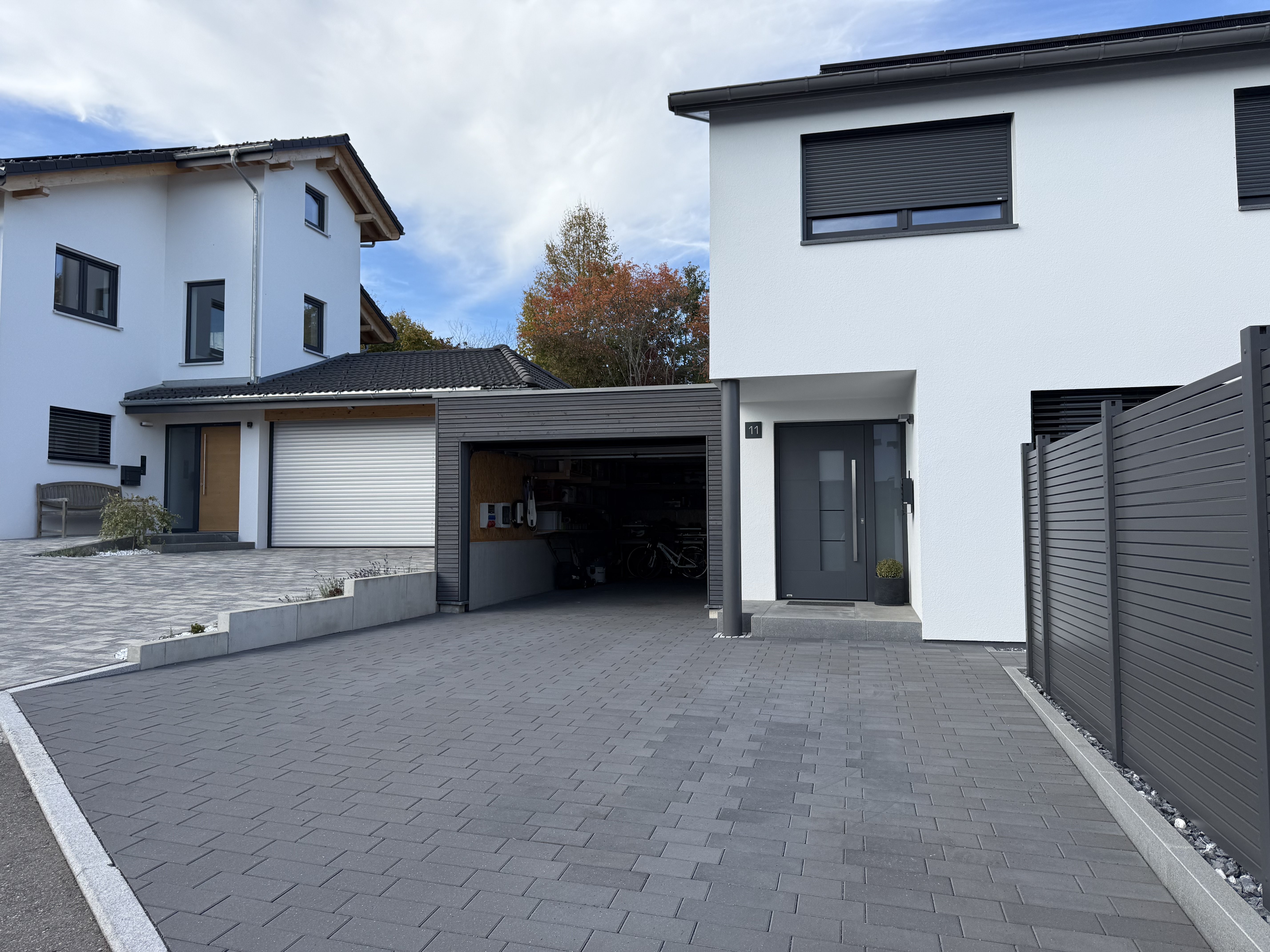 a man in a green shirt holding a pair of gardening tools