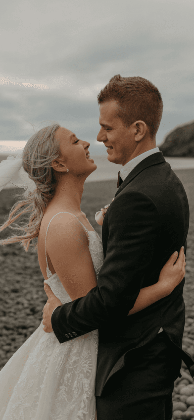 gold-colored bridal ring set on pink rose flower bouquet