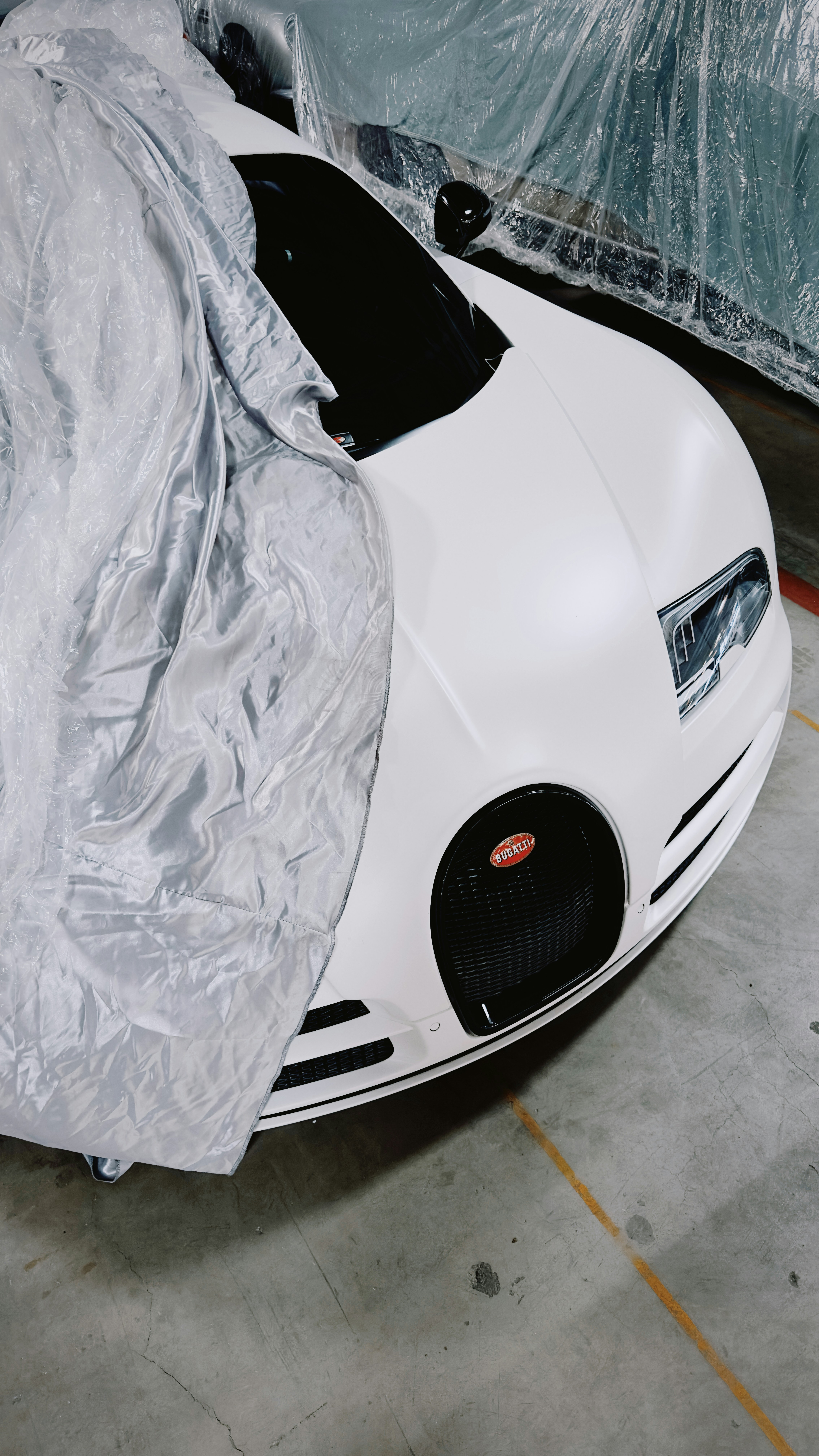 White bugatti car covered with a tarp.