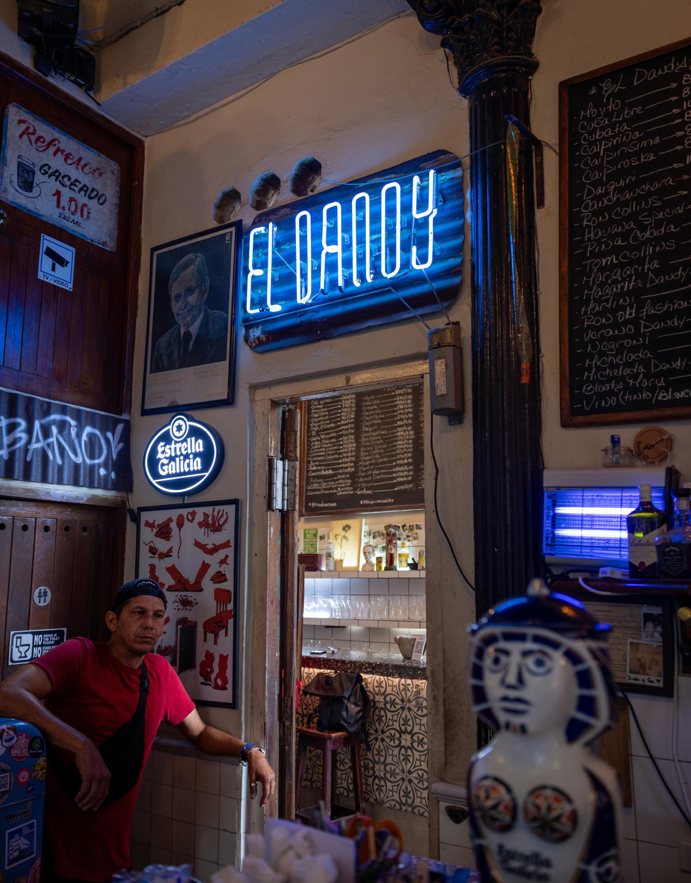 Interior neon sign and local at Bar El Dandy - Havana, Cuba