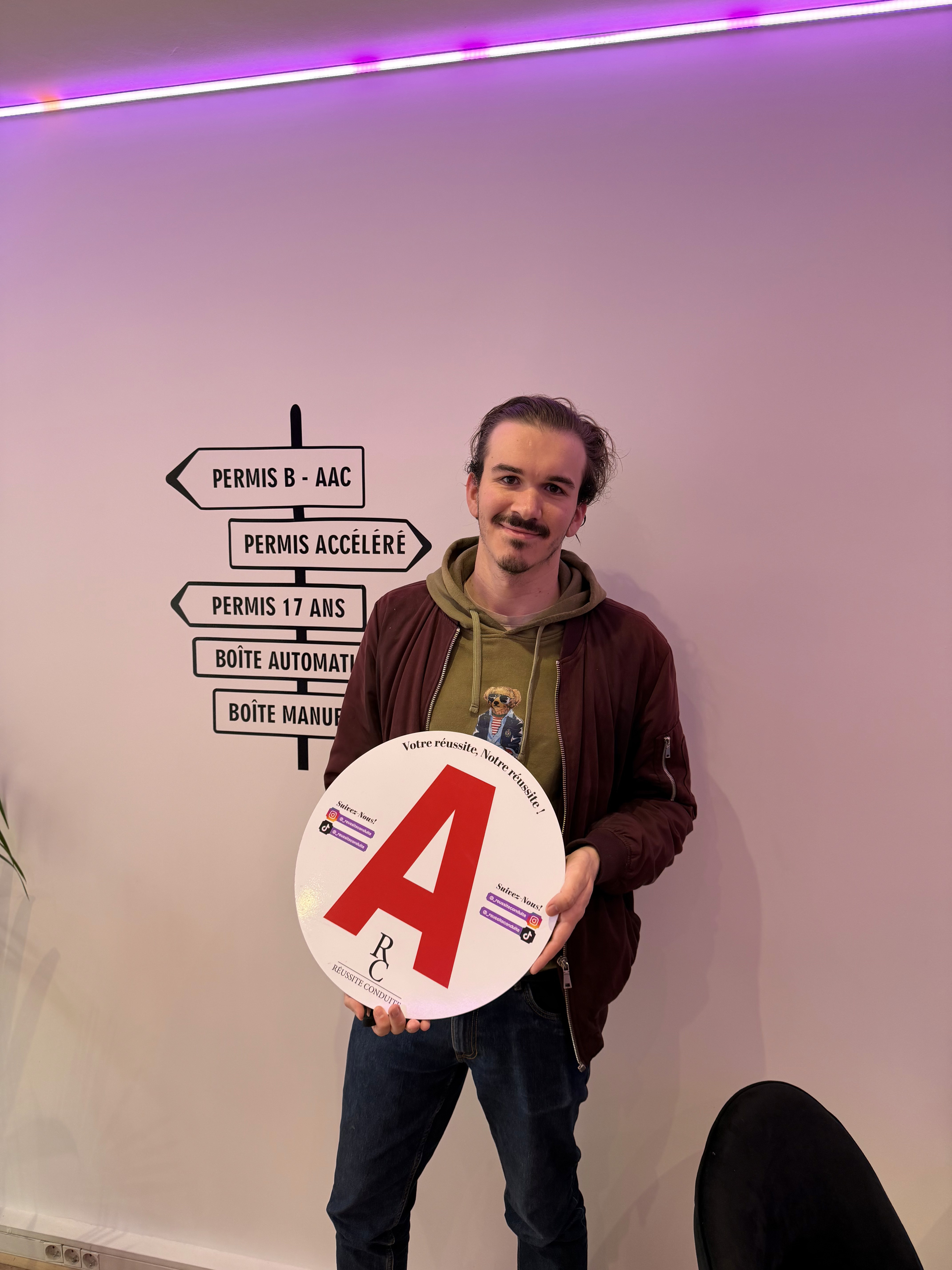 man in black jacket holding blue tablet computer