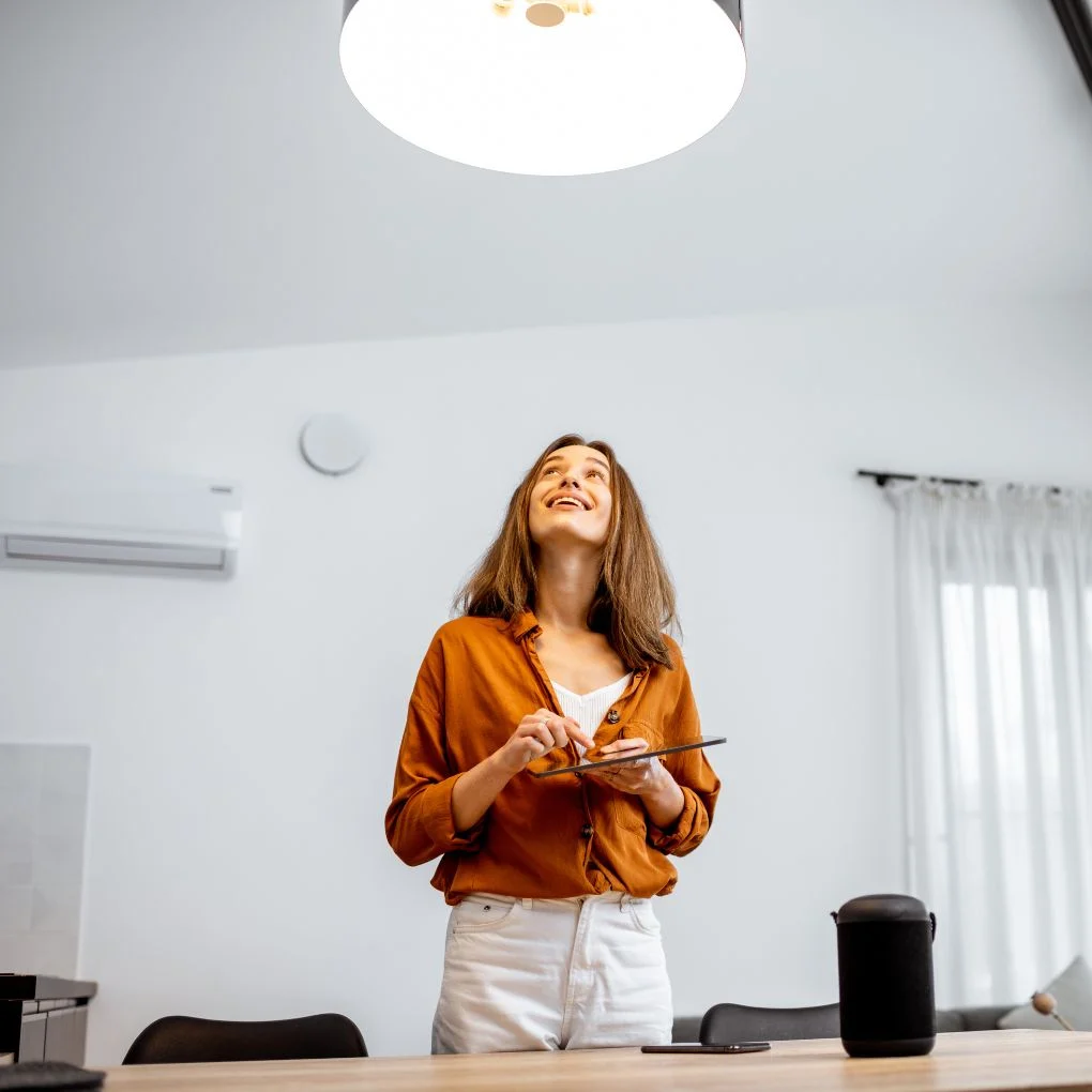 Lady smiling looking at the ceiling holding an iPad