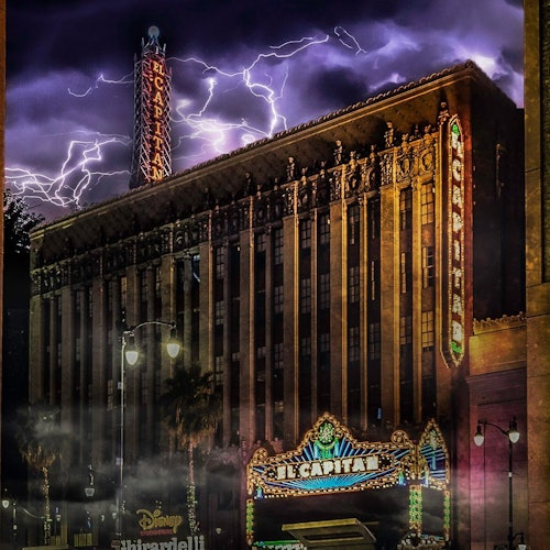 Photo of the El Capitan Theatre in LA, with lightning and clouds overhead