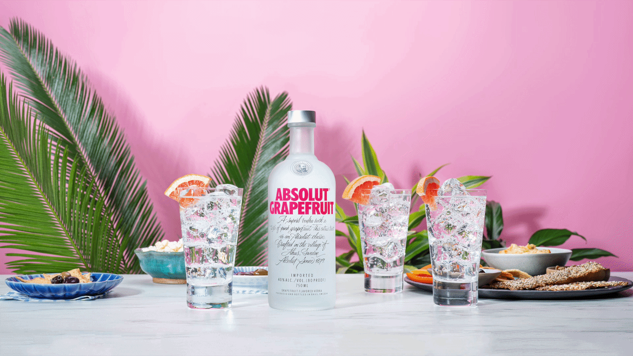 Absolut Grapefruit with iced sodas and grapefruit garnish against a pink backdrop, a motion frame from Ford Media Lab's Absolut production.