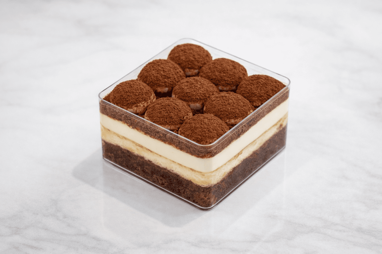 Layered tiramisu dessert with cocoa topping at TruLe Yours Cafe Seattle