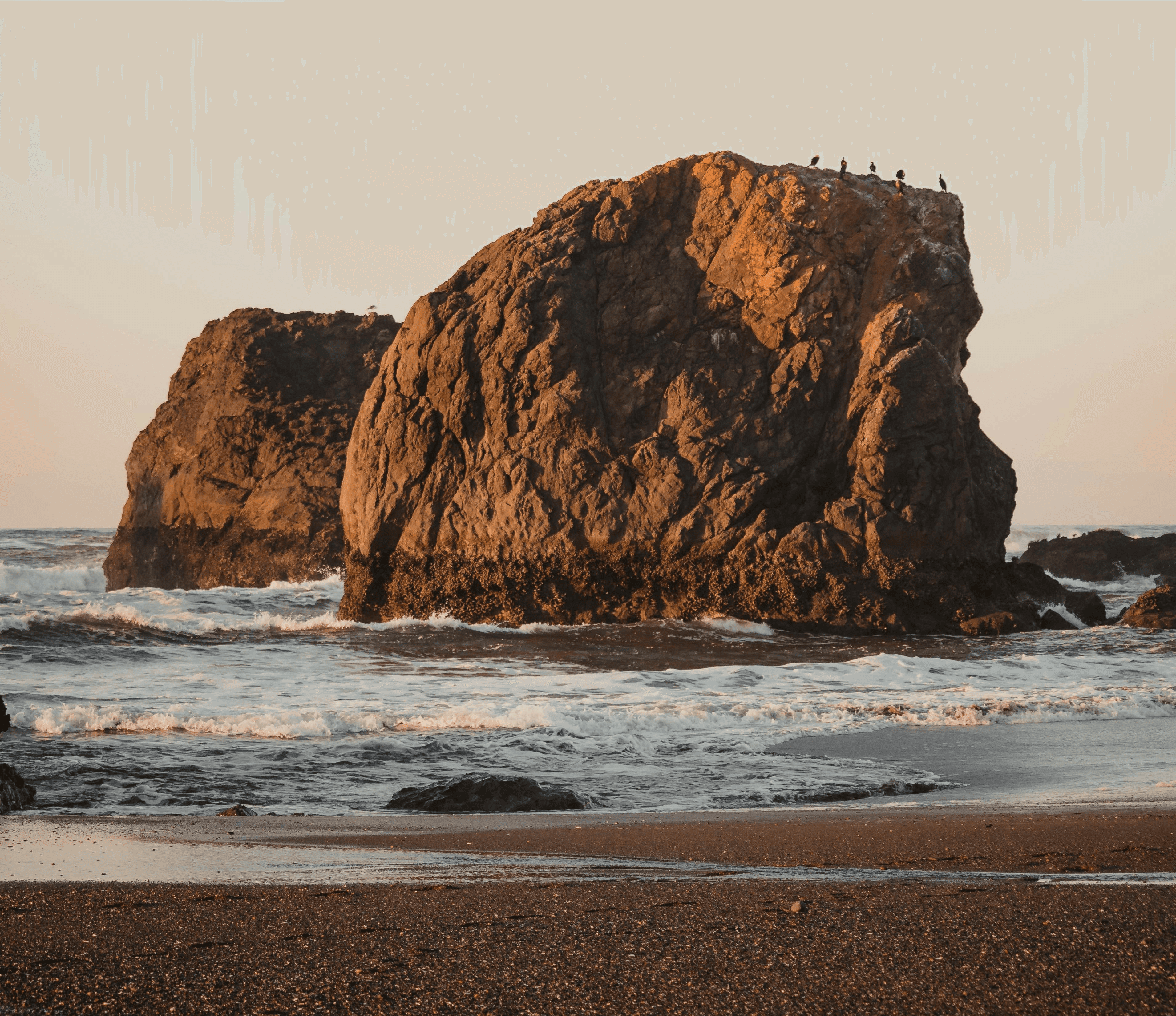 a group of large rocks in the water