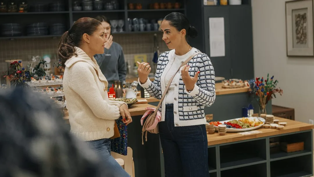 Two mothers in conversation at a Casa Primary gathering