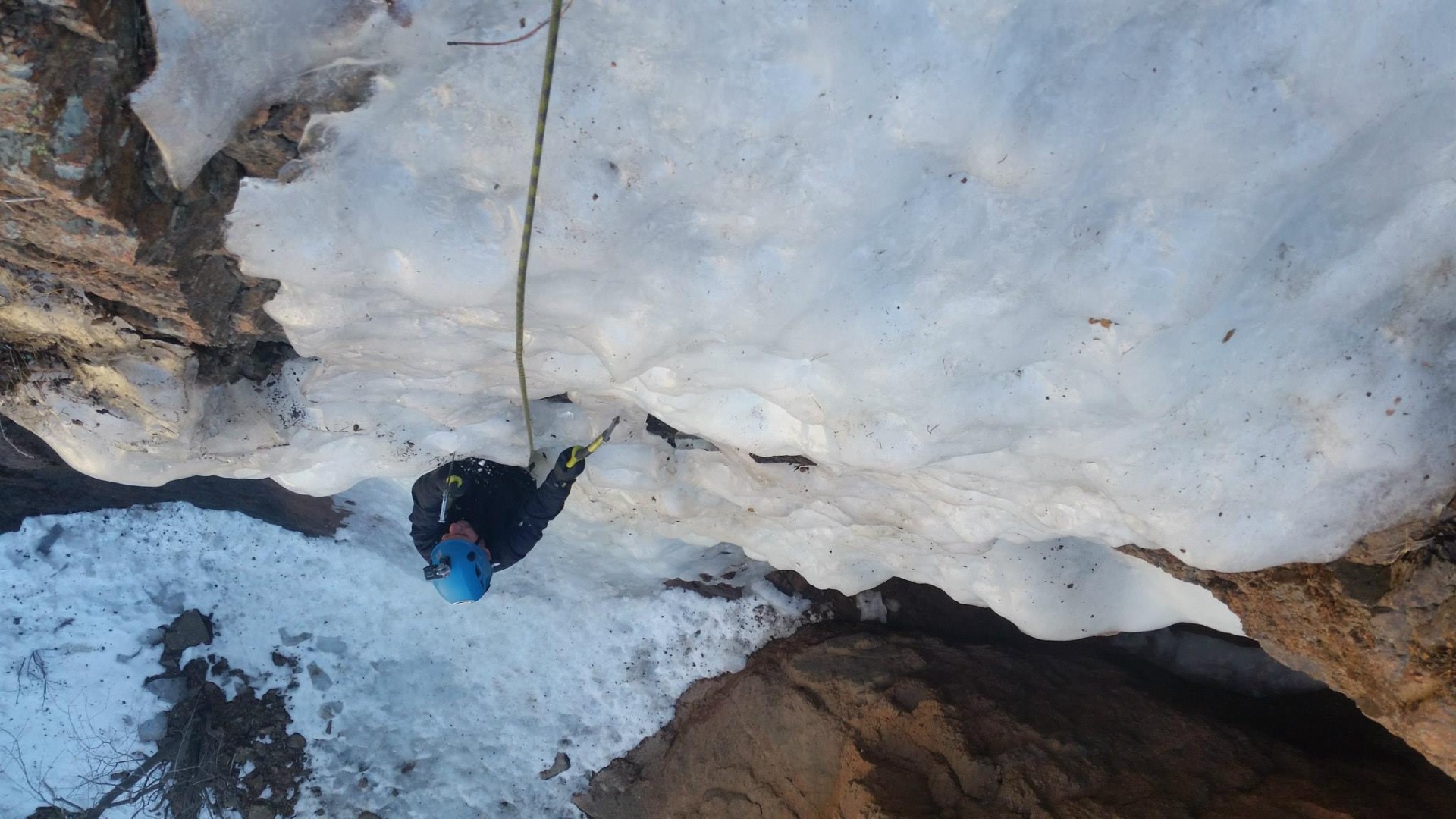 Climber ascends steep curtain of ice