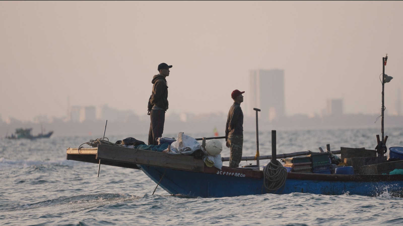 Fishermen standing on their boat off the coast of Da Nang