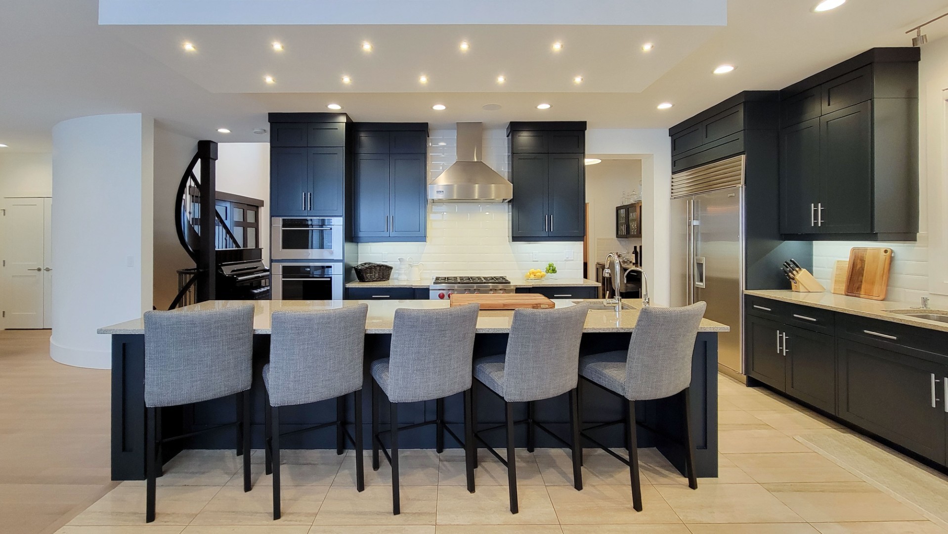 Image of Modern kitchen design with island seating and dark cabinetry by KHD Homes interior design experts.