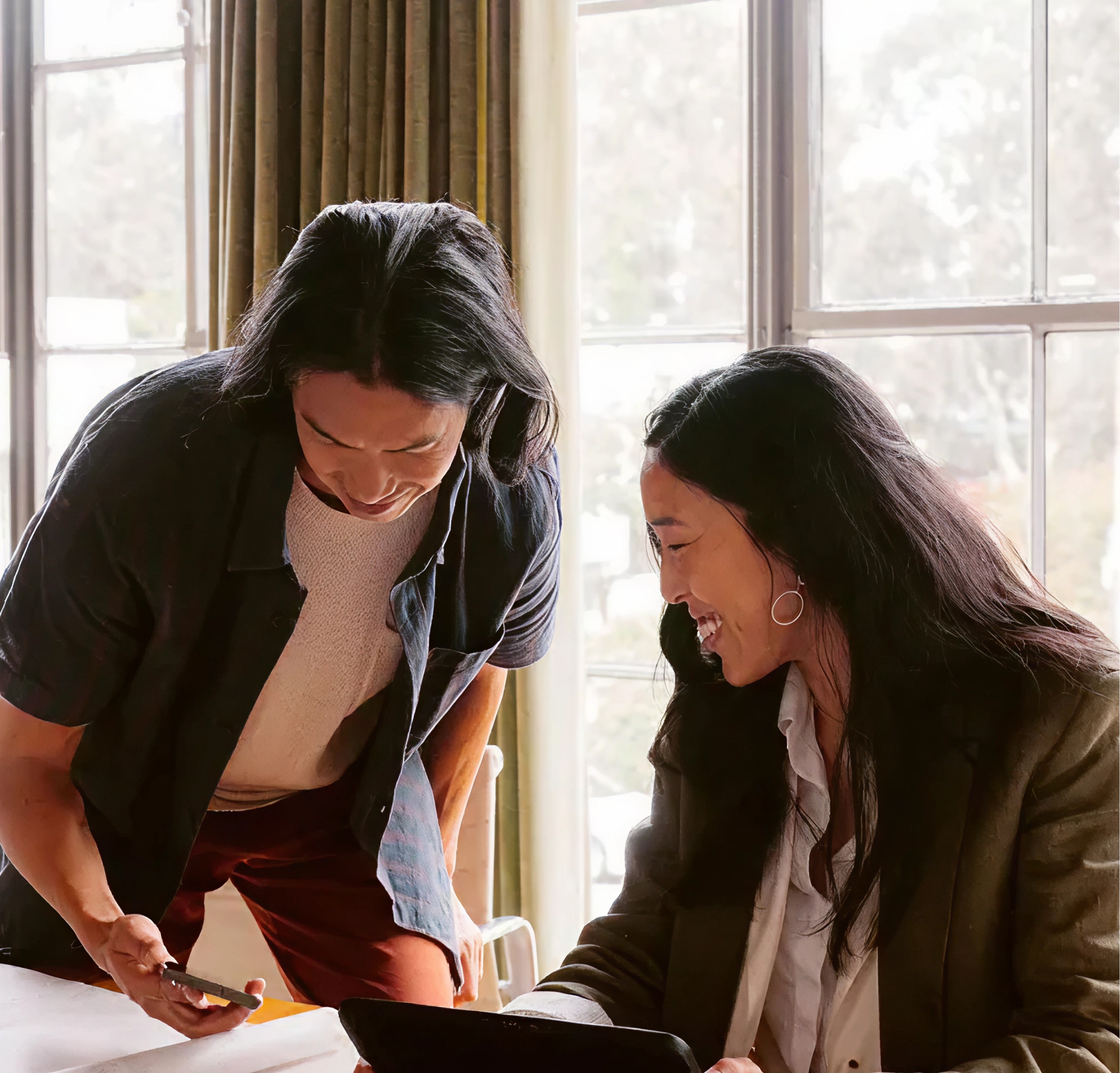 Two students smiling during a language learning session at 612 Academy, reflecting an engaging and human-centered learning experience.